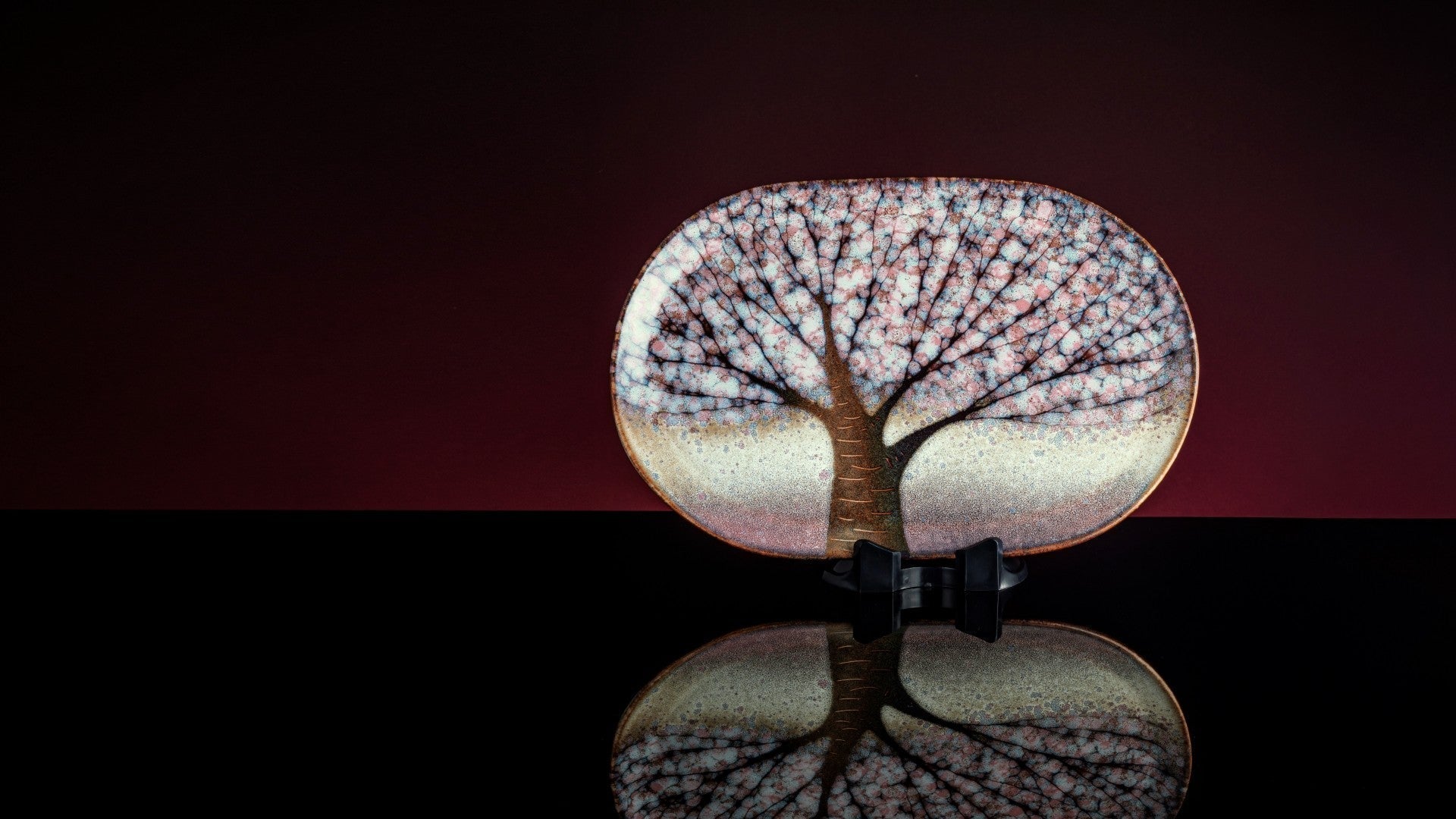 Japanese handcrafted pottery plate with sakura motifs