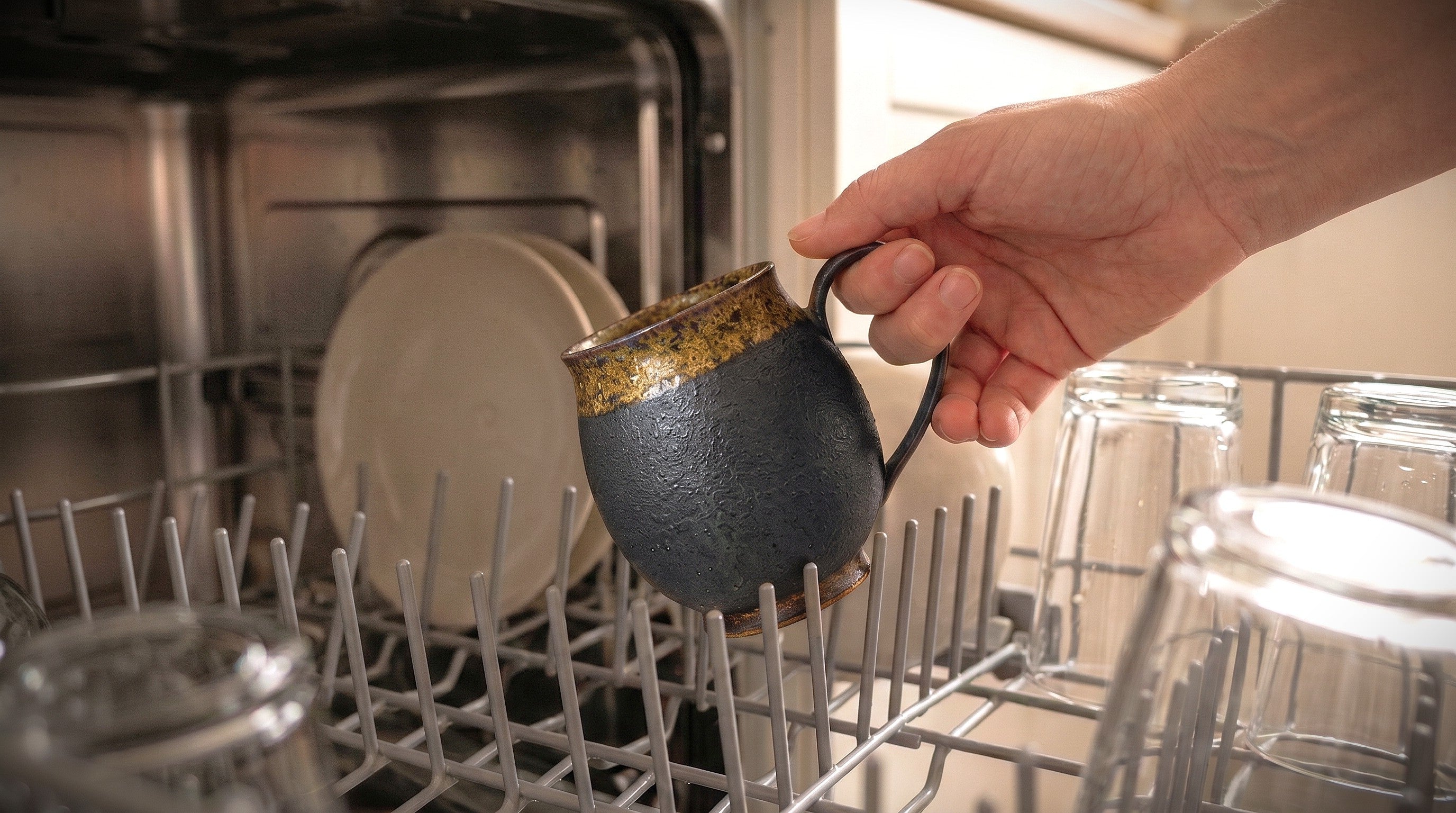 japanese Pottery mug being placed into a dishwasher machine