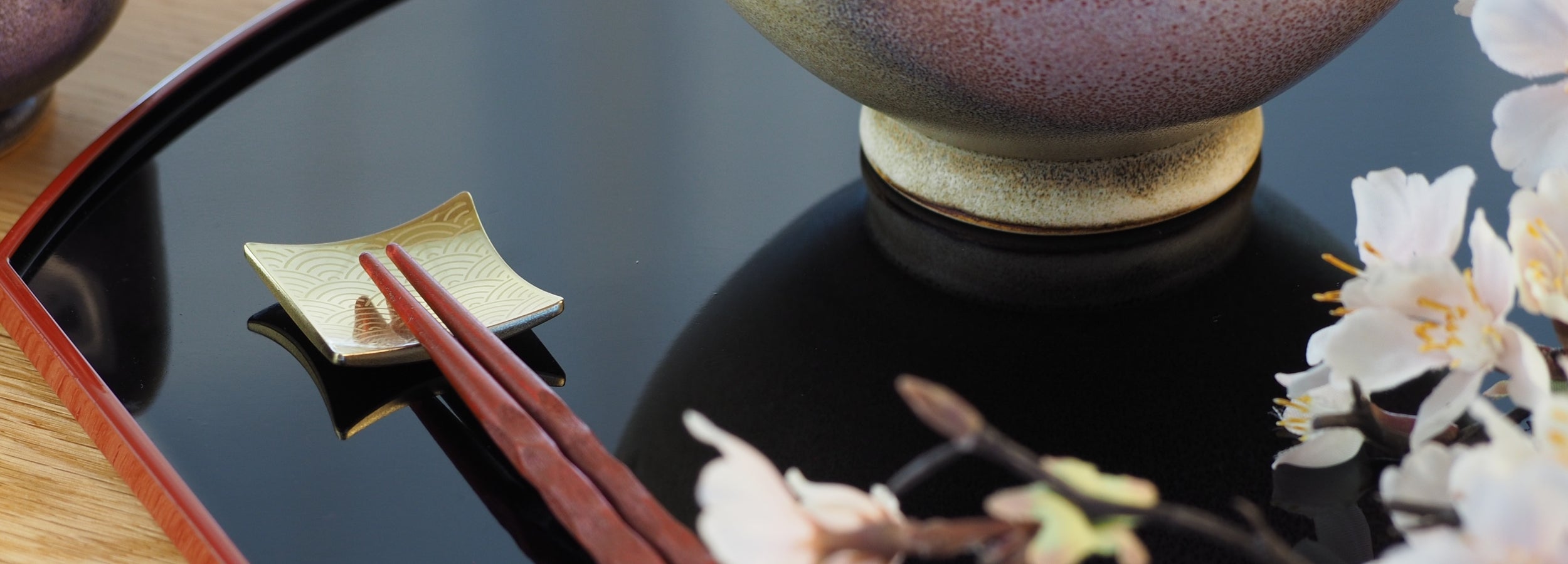 Close-up of a Japanese chopstick rest with a Japanese ceramic rice bowl. Tsukushi