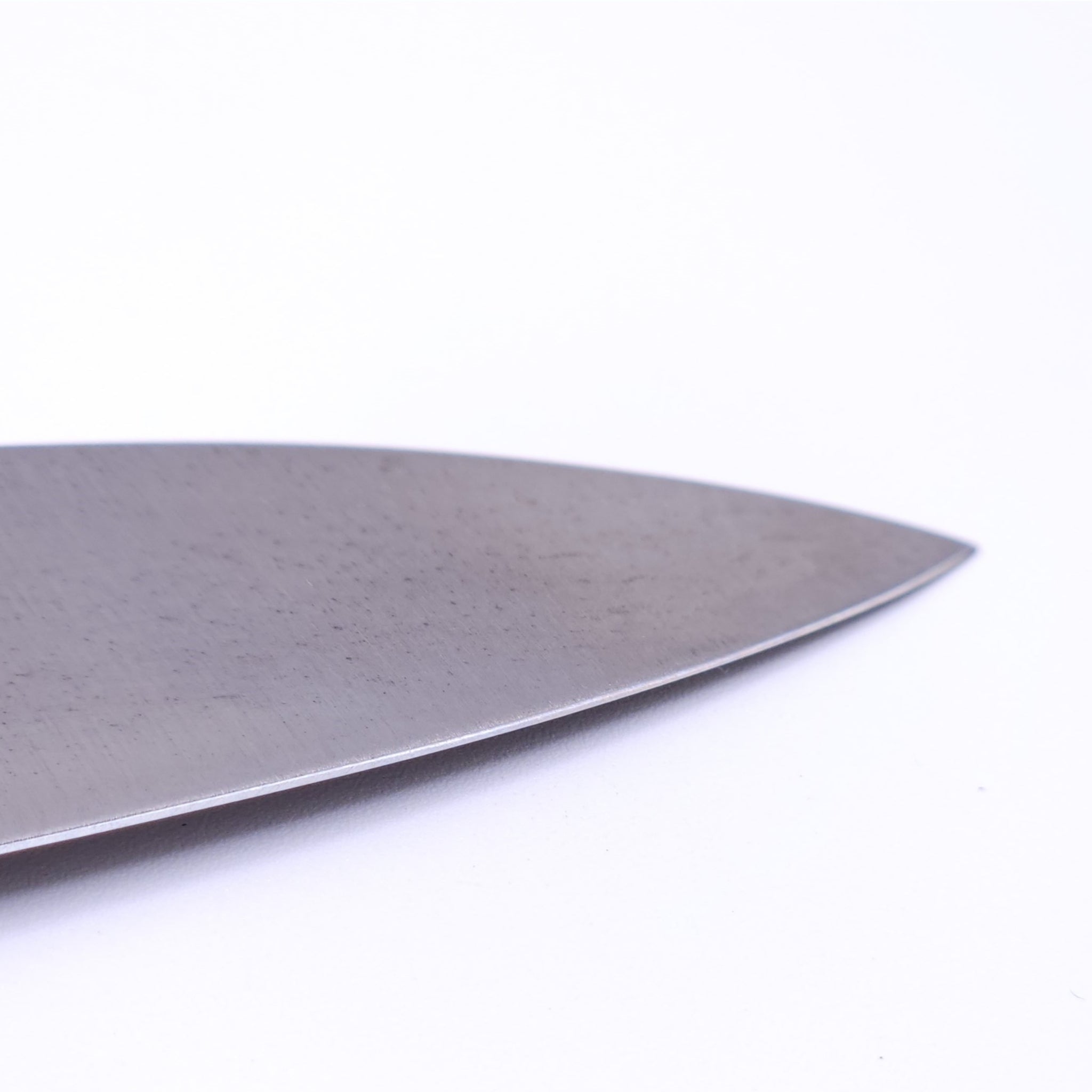 point of a a Japanese Gyuto knife Crafted in Sk Carbon from Minamoto Mitsukane cutlery,180mm.