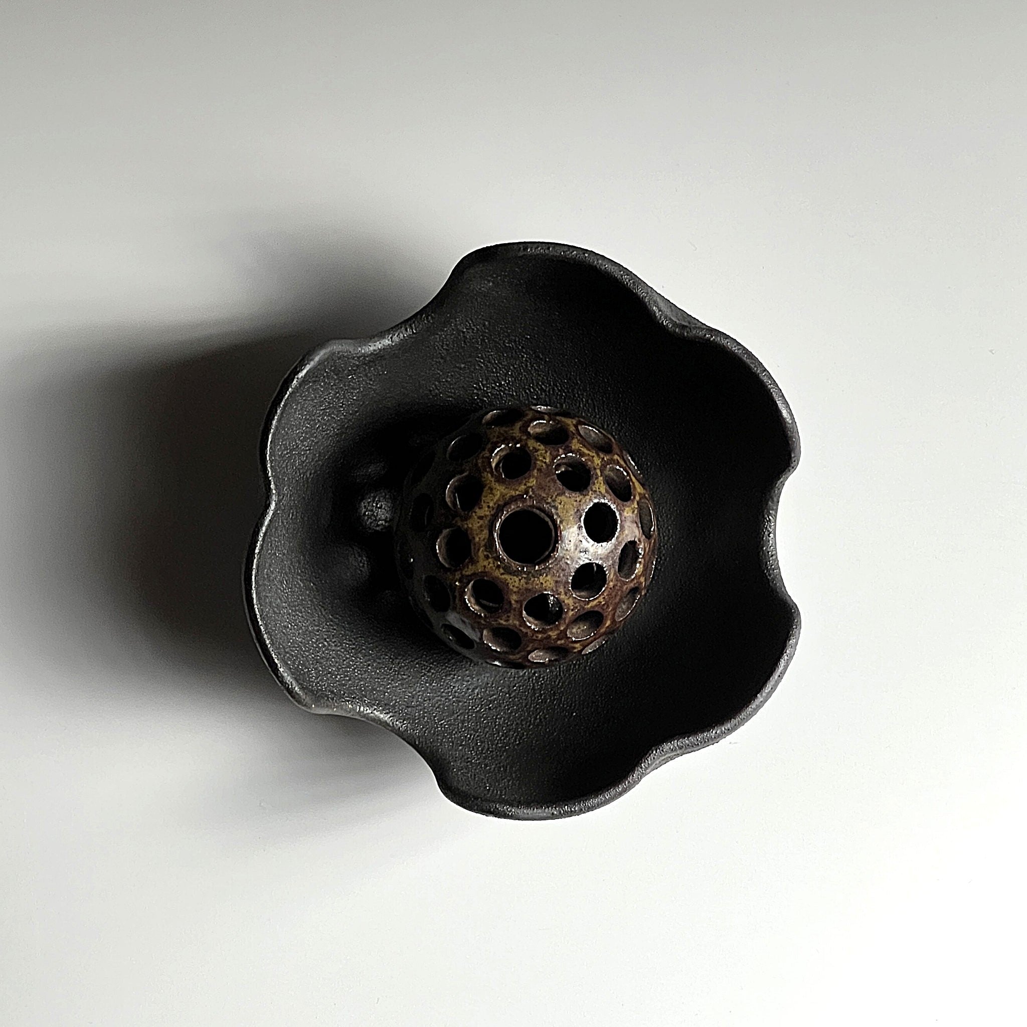 Top view of a Ikebana vase with ceramic flower frog and matching bowl. Tsukushi.