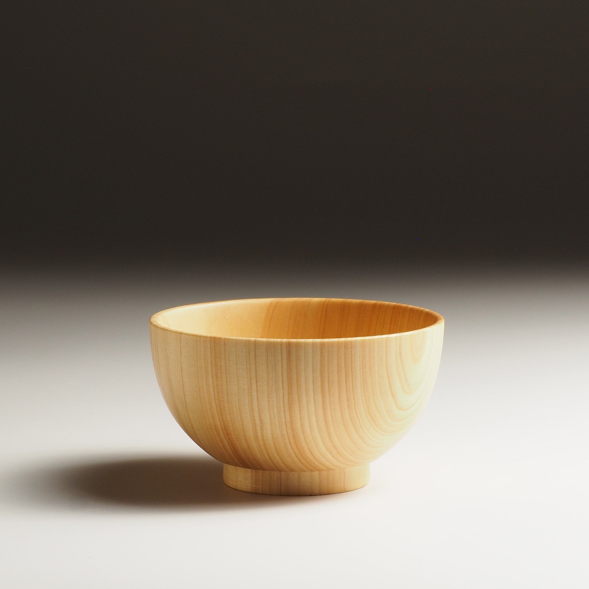 Japanese wooden macha tea bowl on a beige background. Tsukushi
