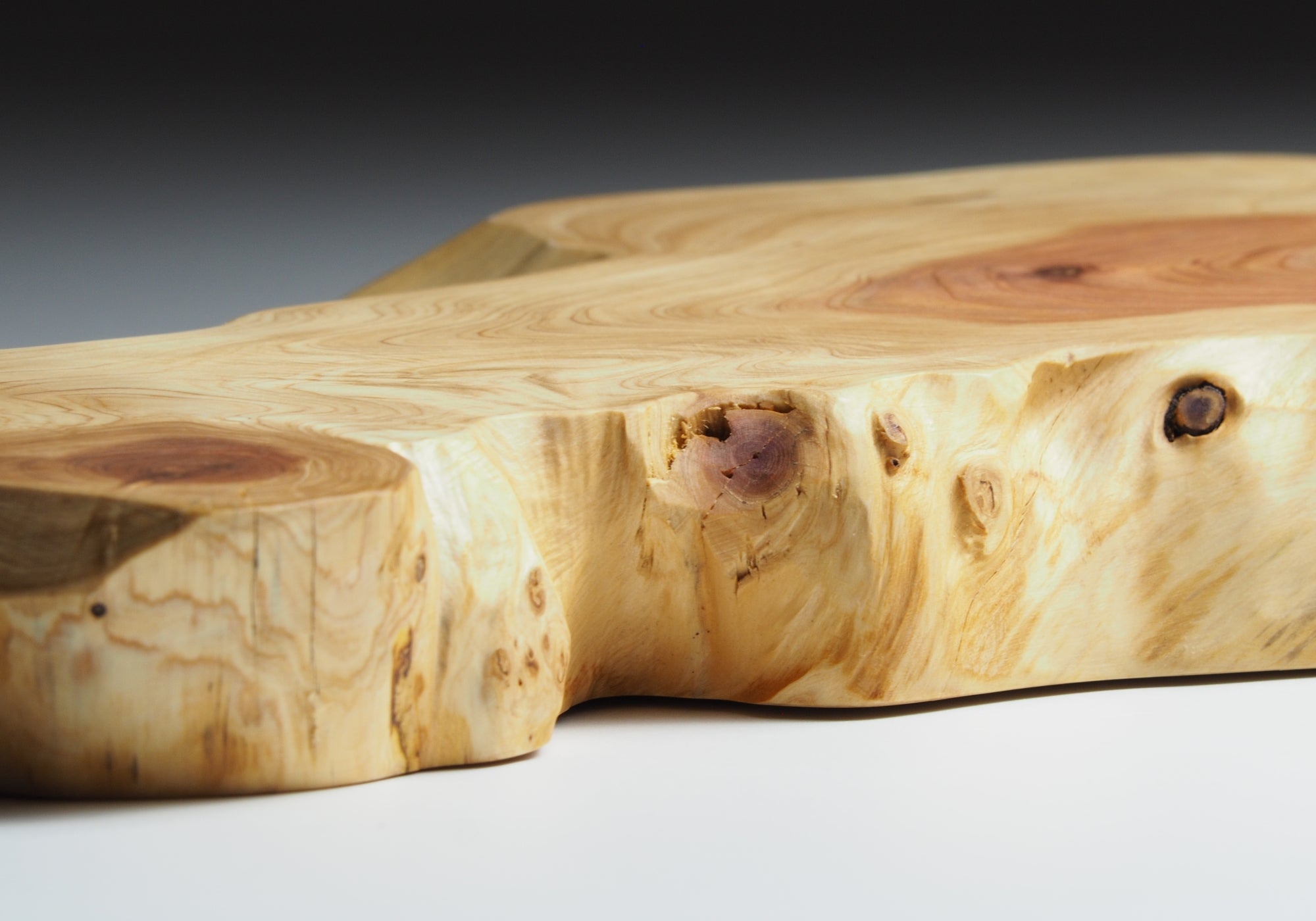 Detail view of Japanese wooden sushi tray on a beige background. Tsukushi