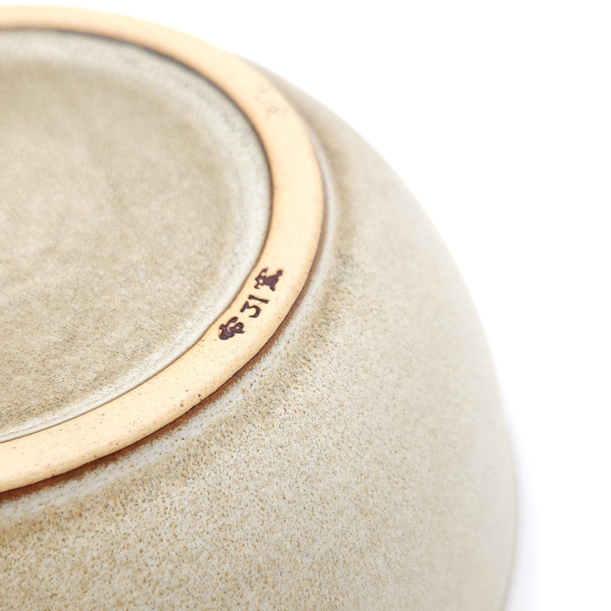 Authentic Japanese pottery salad bowl with cherry blossoms decoration. green and beige color. (bottom detail view 1).