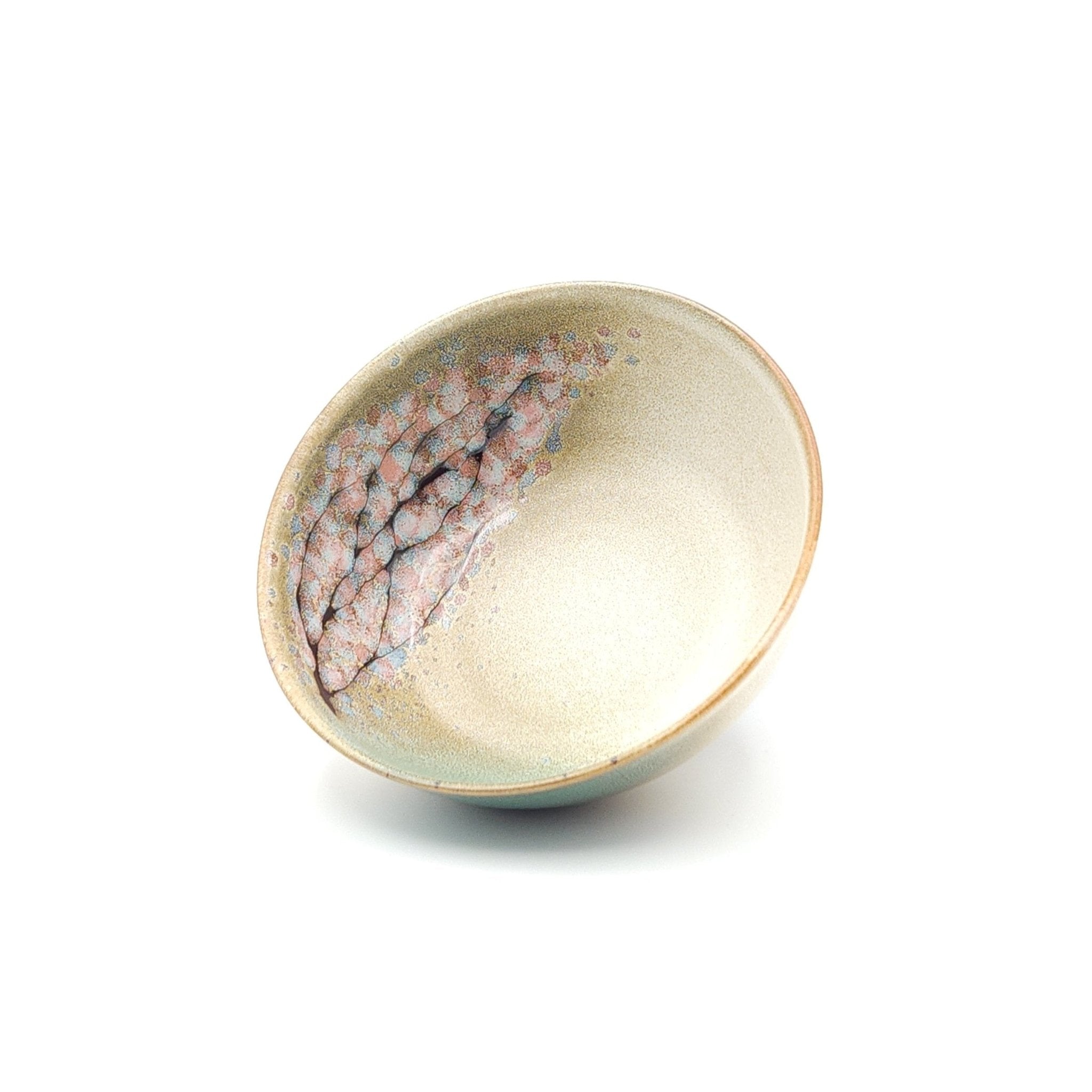 Authentic Japanese pottery salad bowl with cherry blossoms decoration. Green and beige color. (front side view 1).