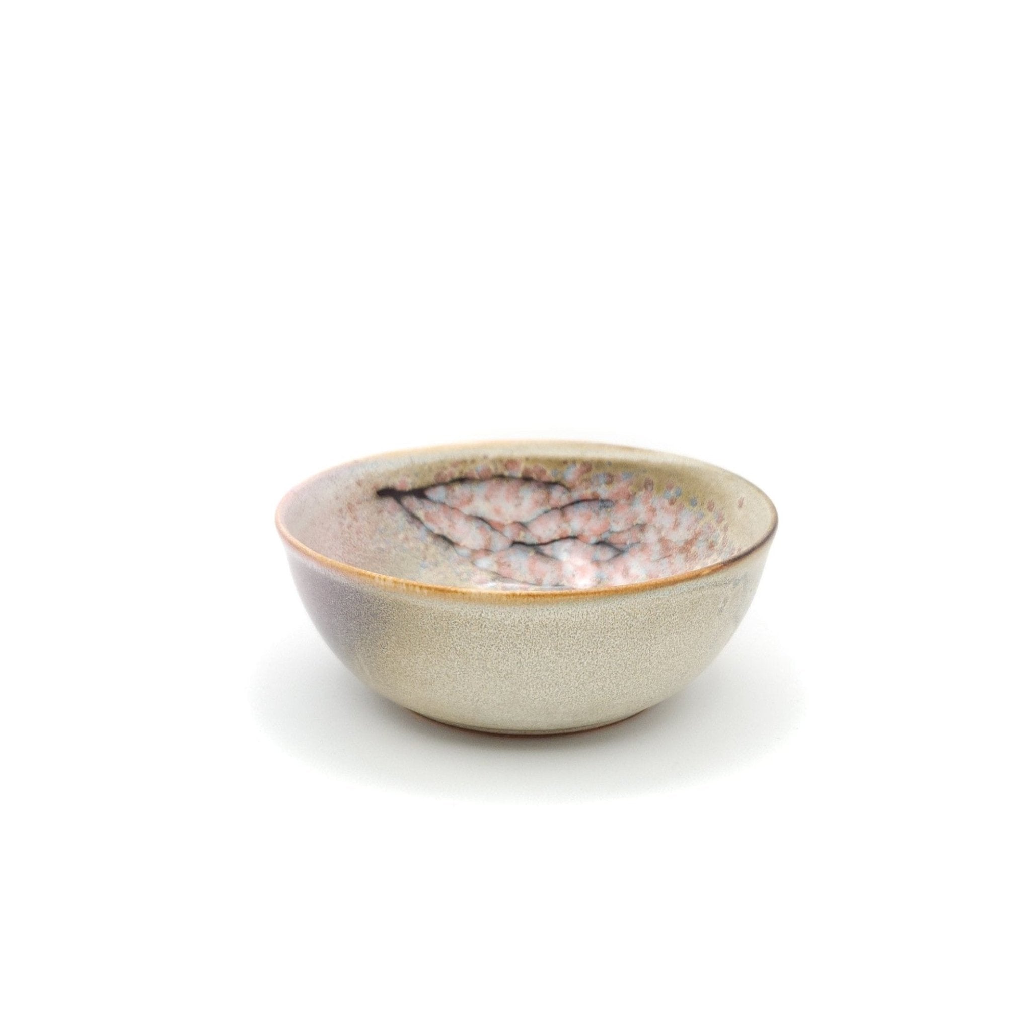 Authentic Japanese pottery salad bowl with cherry blossoms decoration. Pink and beige color. (side view 3).