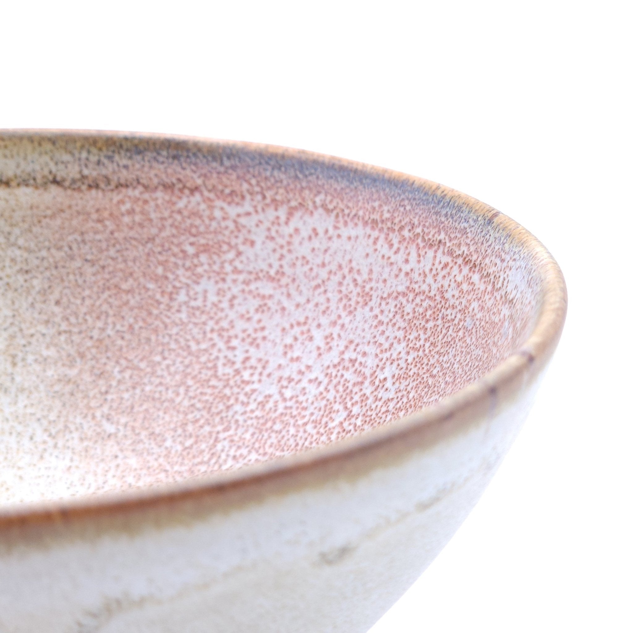 Authentic Japanese pottery bowl with cherry blossoms decoration. Pink and beige color. (side detail view 1).