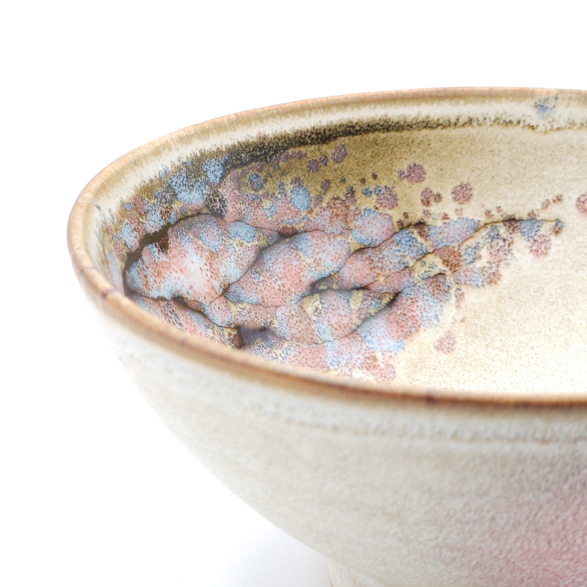 Authentic Japanese pottery bowl with cherry blossoms decoration. Pink and beige color. (side detail view 2).