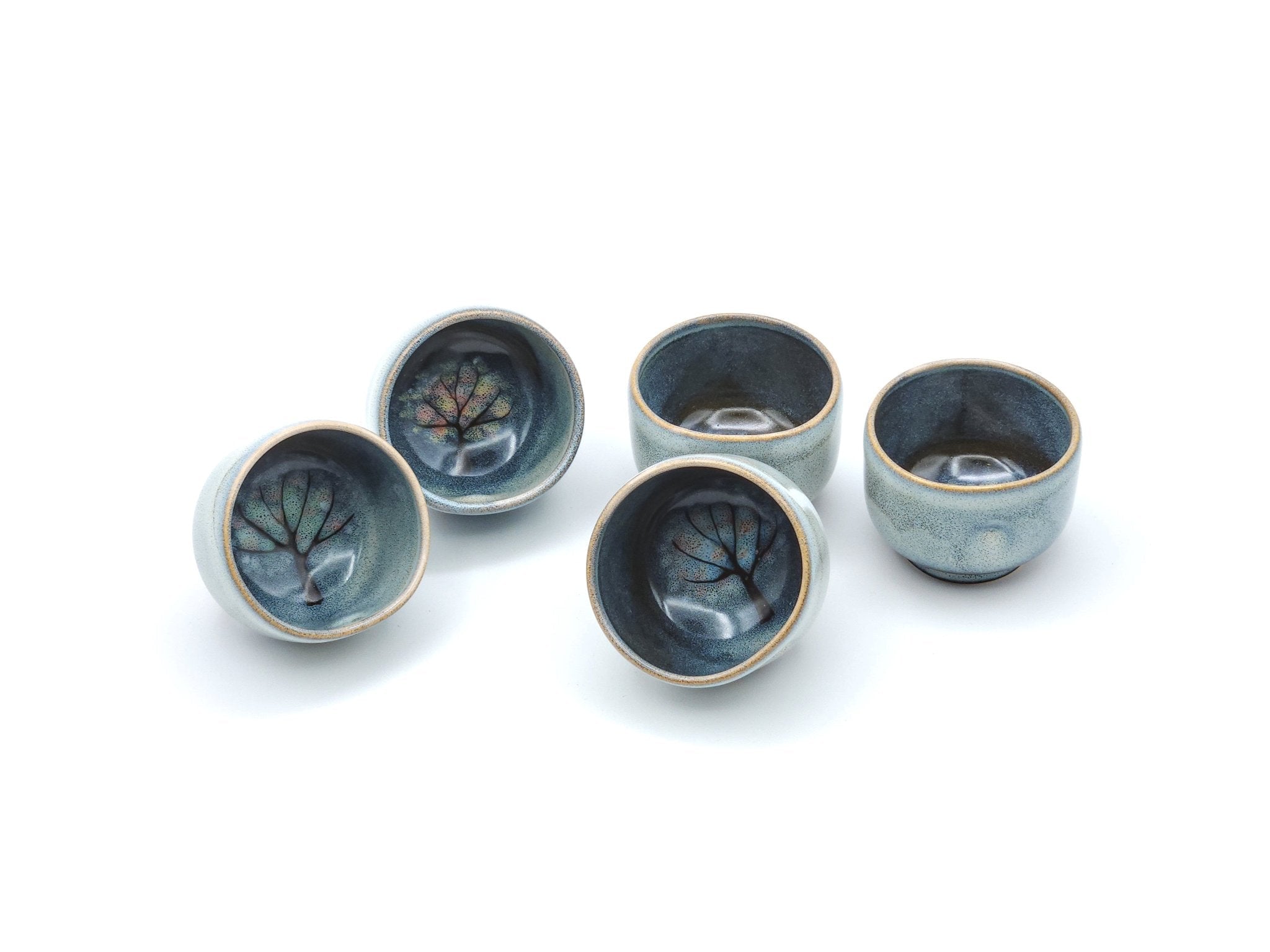 Authentic Japanese pottery teacup with tree decoration. blue and white color. (set view 1).