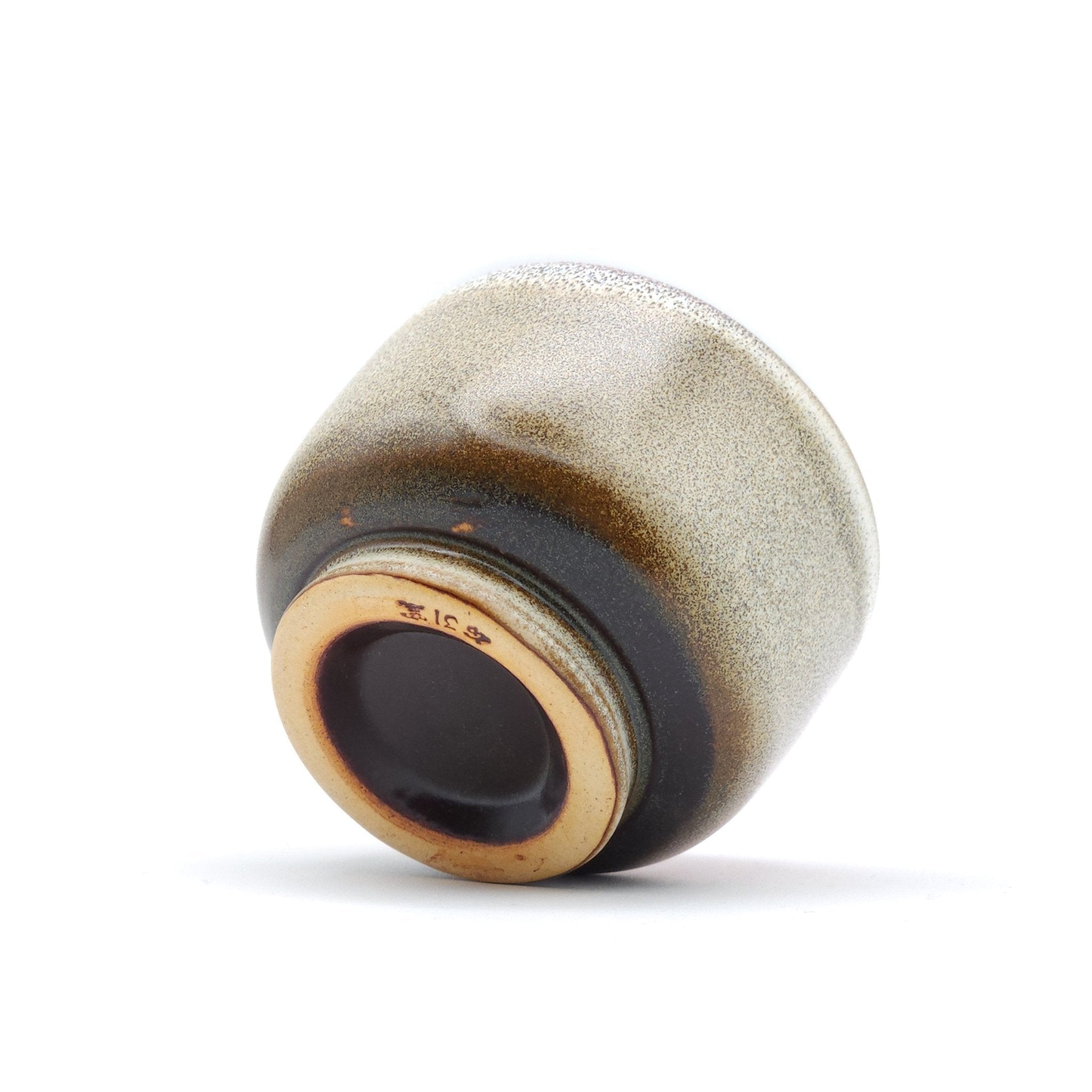 Authentic Japanese pottery teacup with cherry blossoms decoration. pick and beige color.  (bottom view 2).