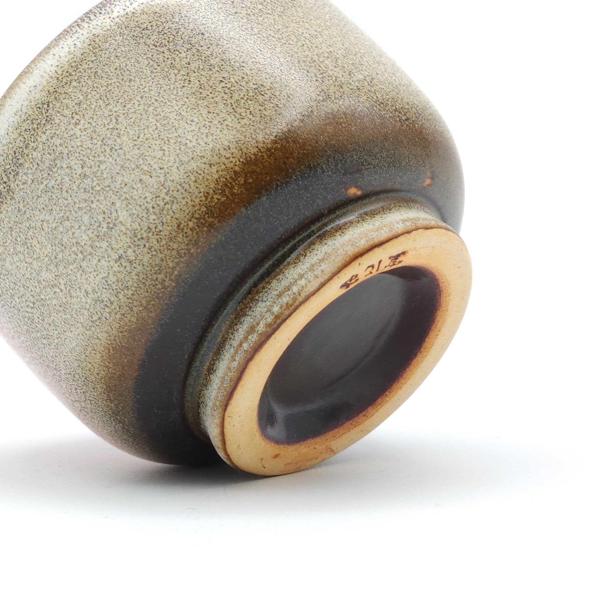 Authentic Japanese pottery teacup with cherry blossoms decoration. pick and beige color.  (bottom detail view 1).