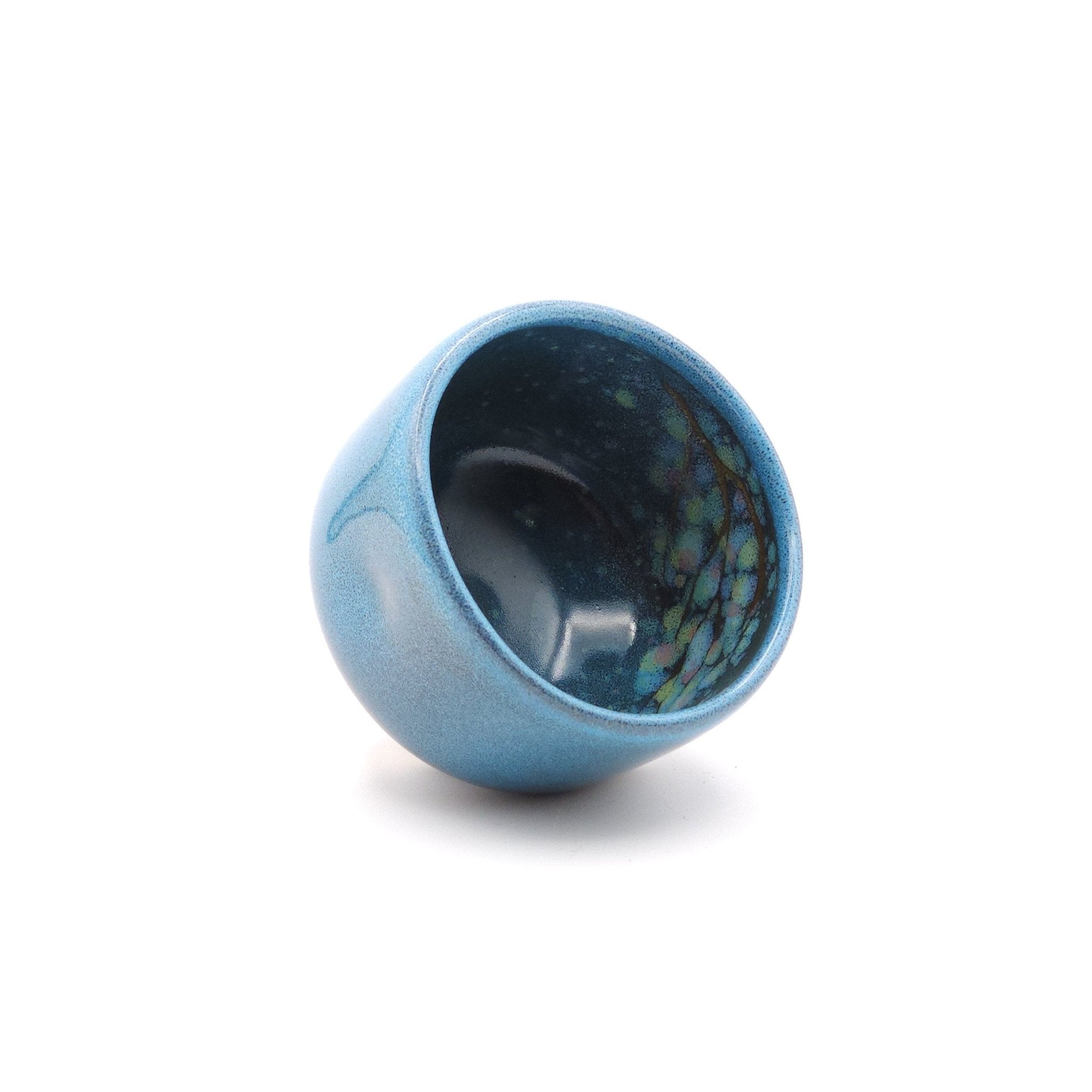 Authentic Japanese pottery teacup with tree pattern decoration. blue color. (front side view 2).