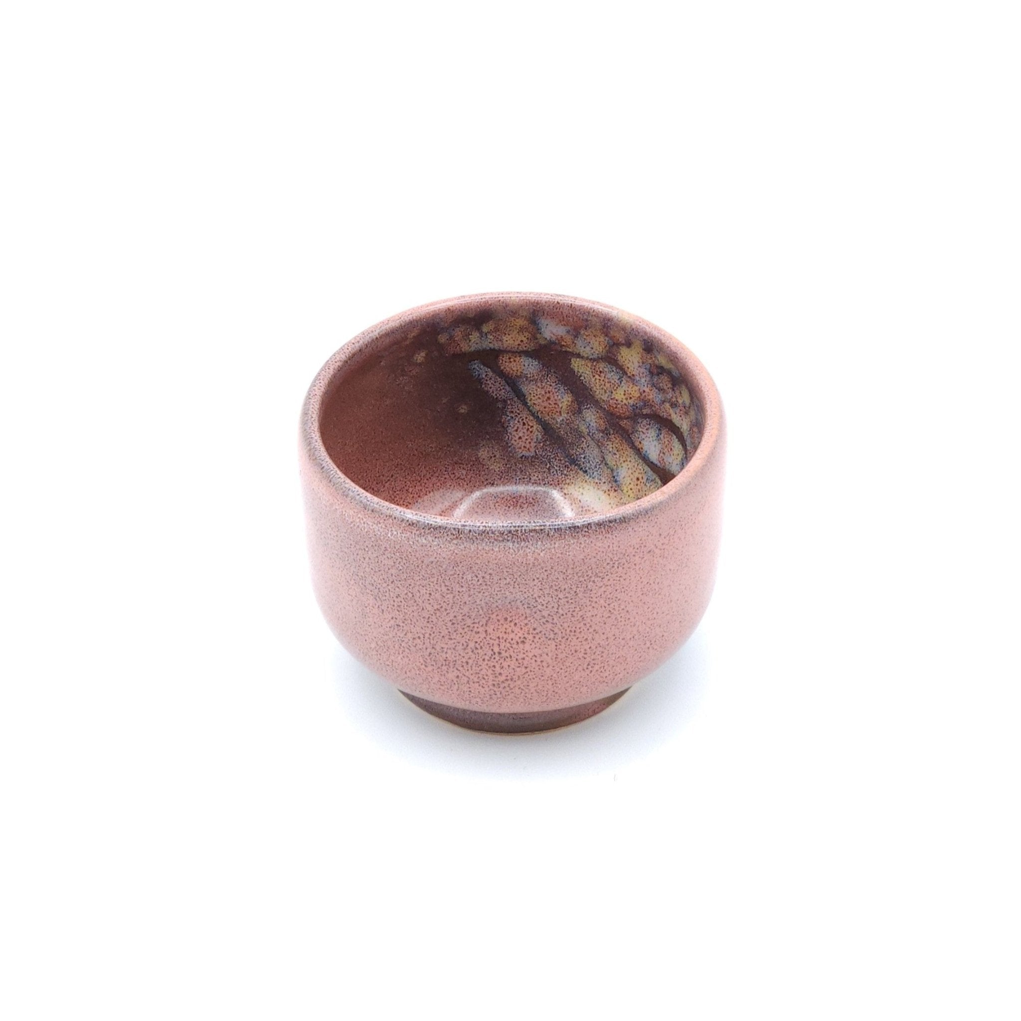 Authentic Japanese pottery teacup with tree pattern decoration. pink color. (front side view 1).