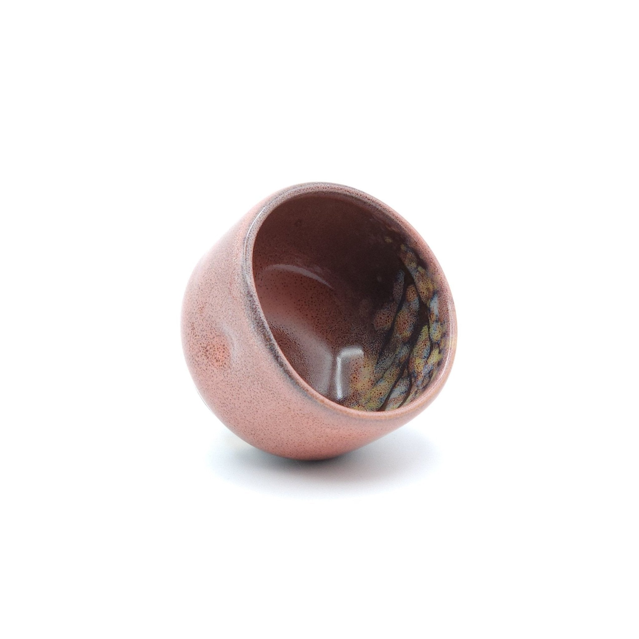 Authentic Japanese pottery teacup with tree pattern decoration. pink color. (front side view 2).