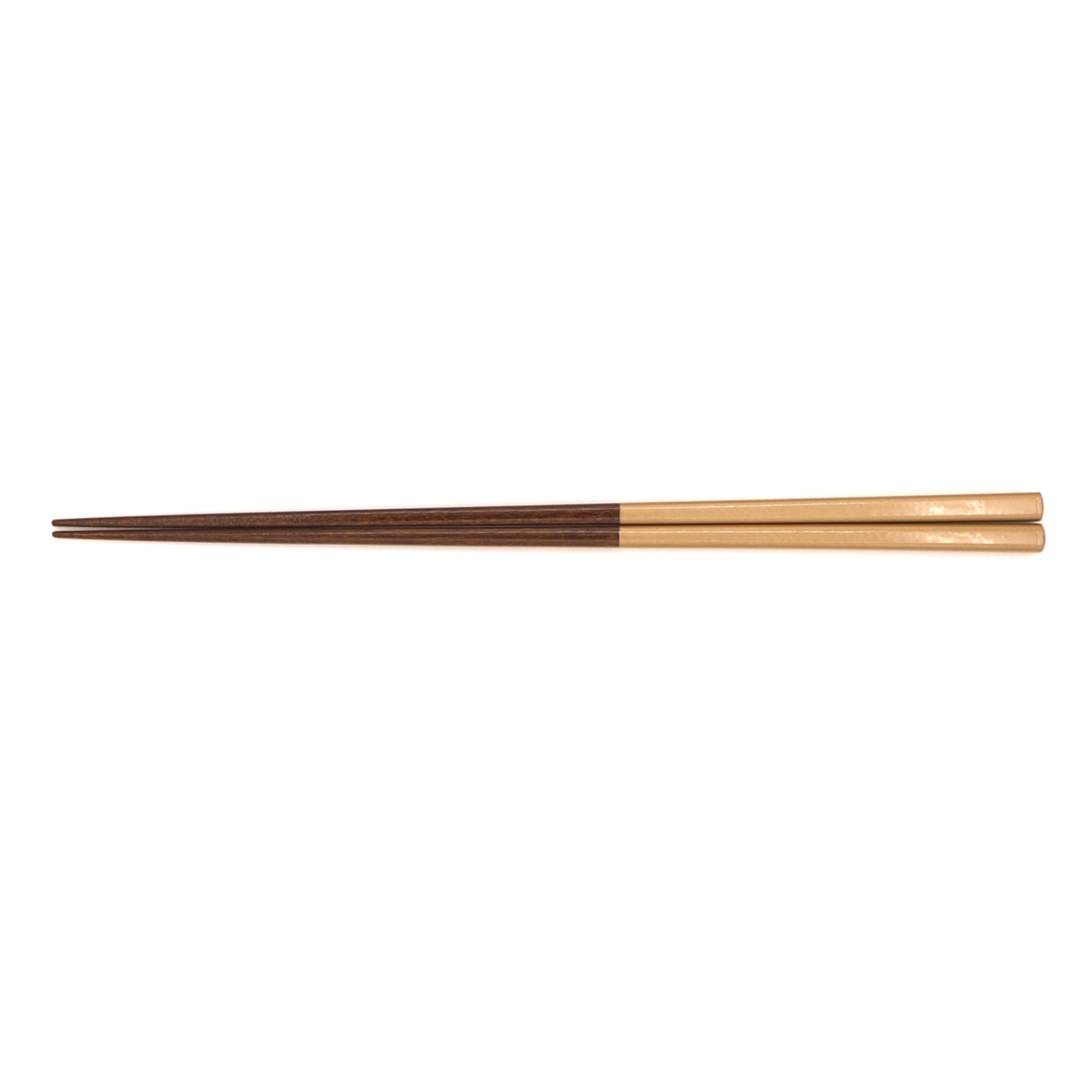 Golden Japanese wooden chopsticks. View from top