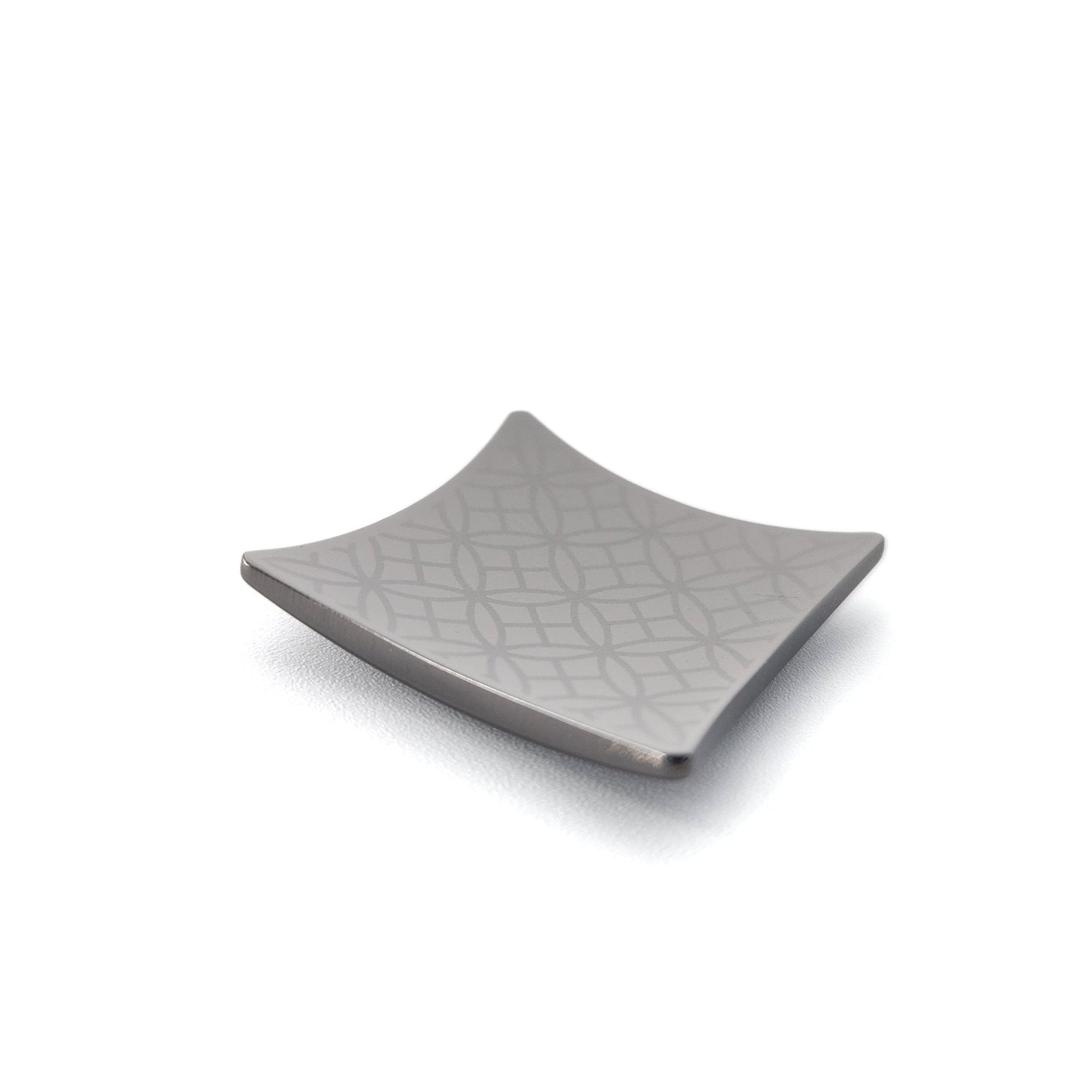 A Japanese Chopsticks rest in black metal with squares and rounds pattern