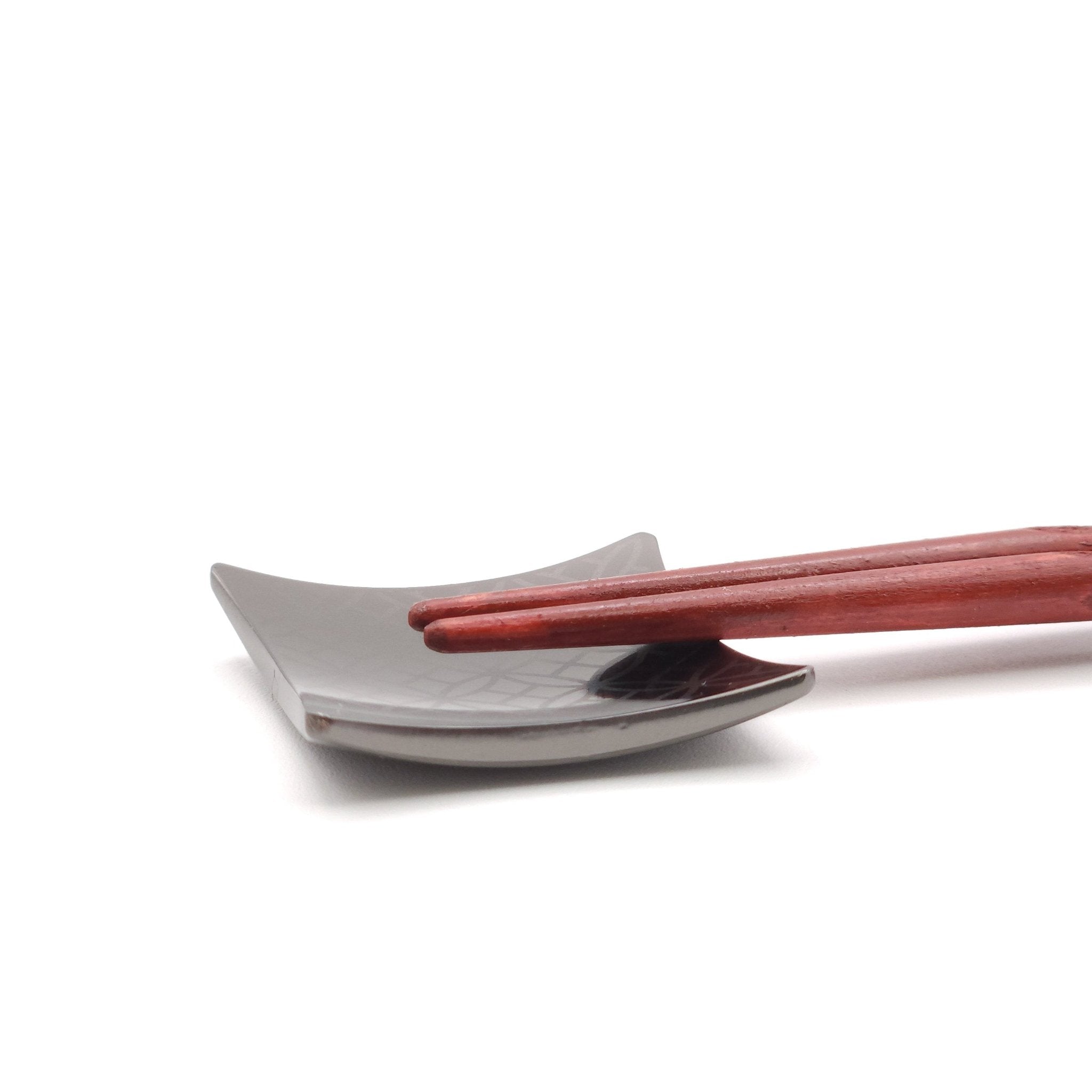 A Japanese Chopsticks rest in black metal with Chopsticks on top 2