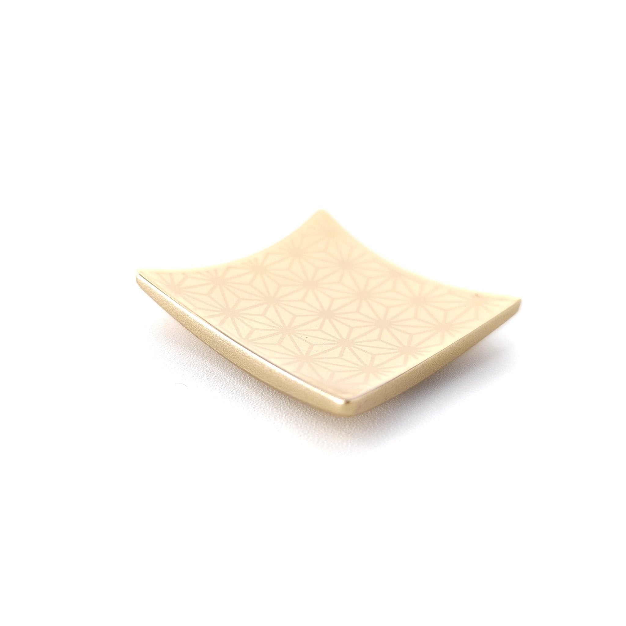 A Japanese Chopsticks rest in golden metal with Nezuko style pattern.