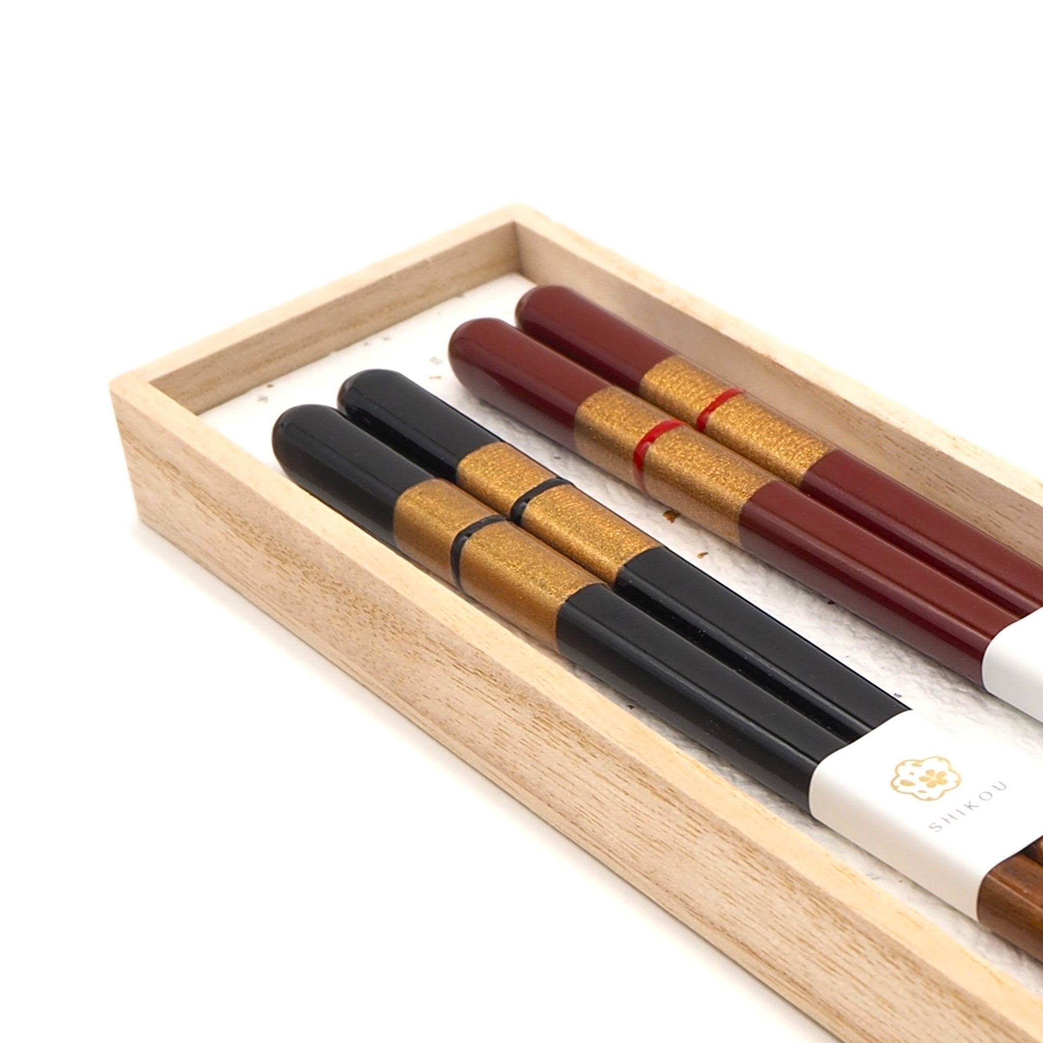 Black and red Japanese Chopsticks with golden motif inside a box