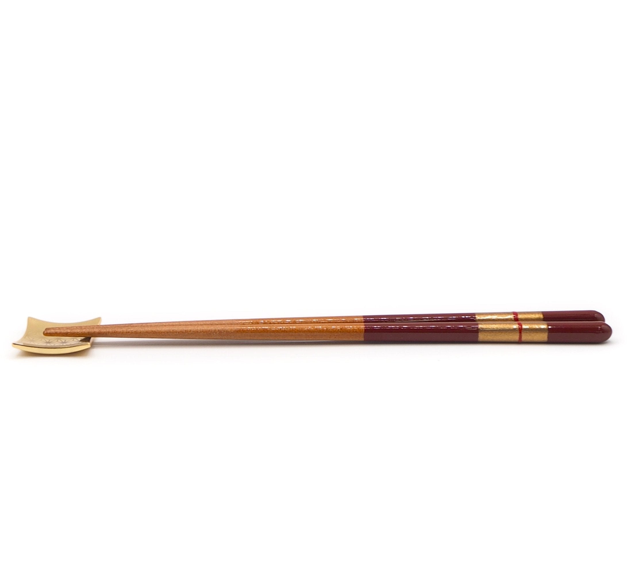 Side view of red Japanese Chopsticks with golden motif