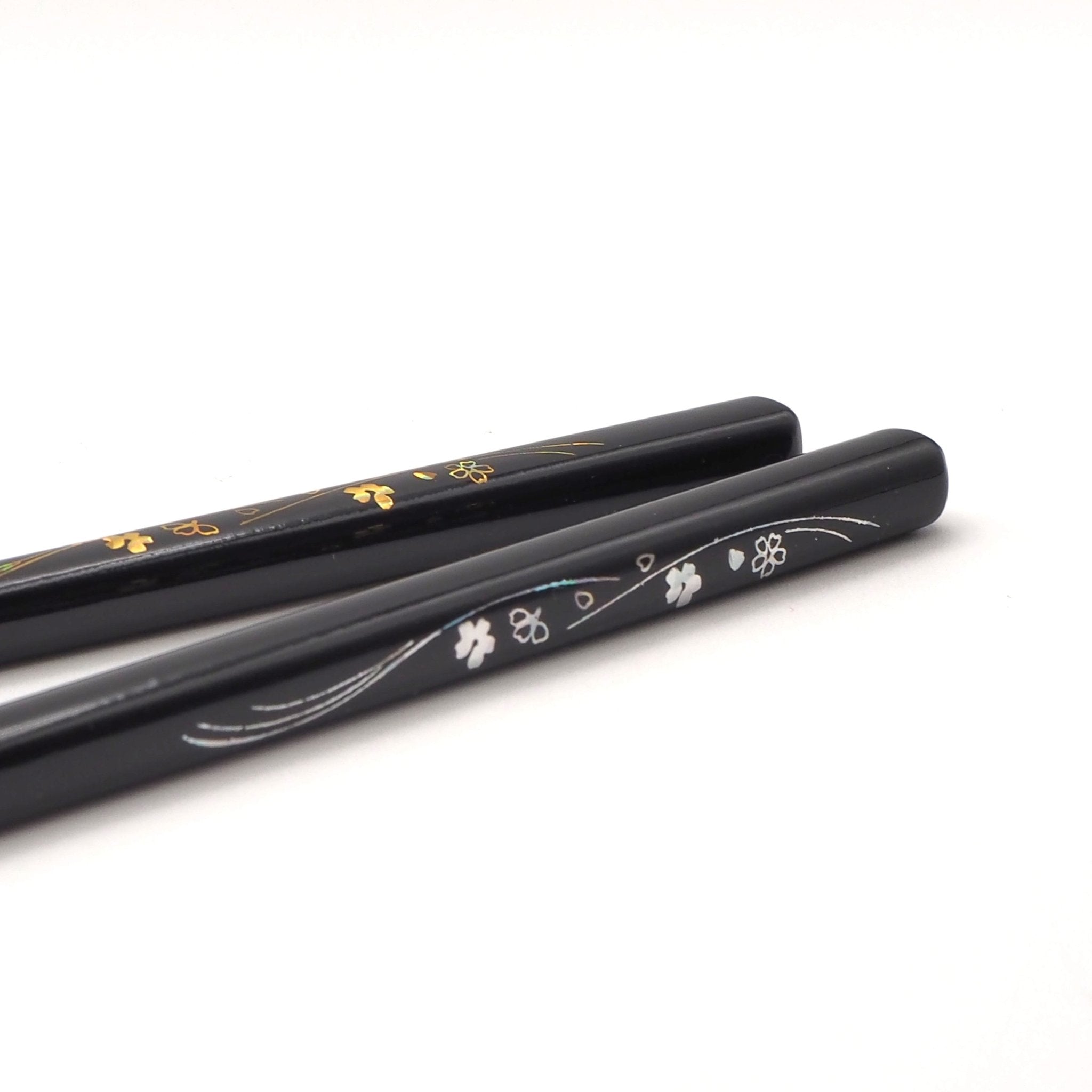 Detail of black Japanese chopsticks with cherry blossom motifs