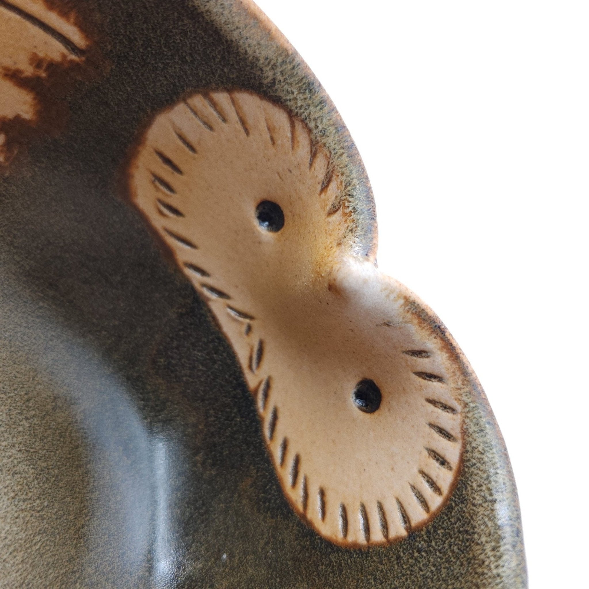 Detail of a Japanese teacup made of pottery with an Owl motif.