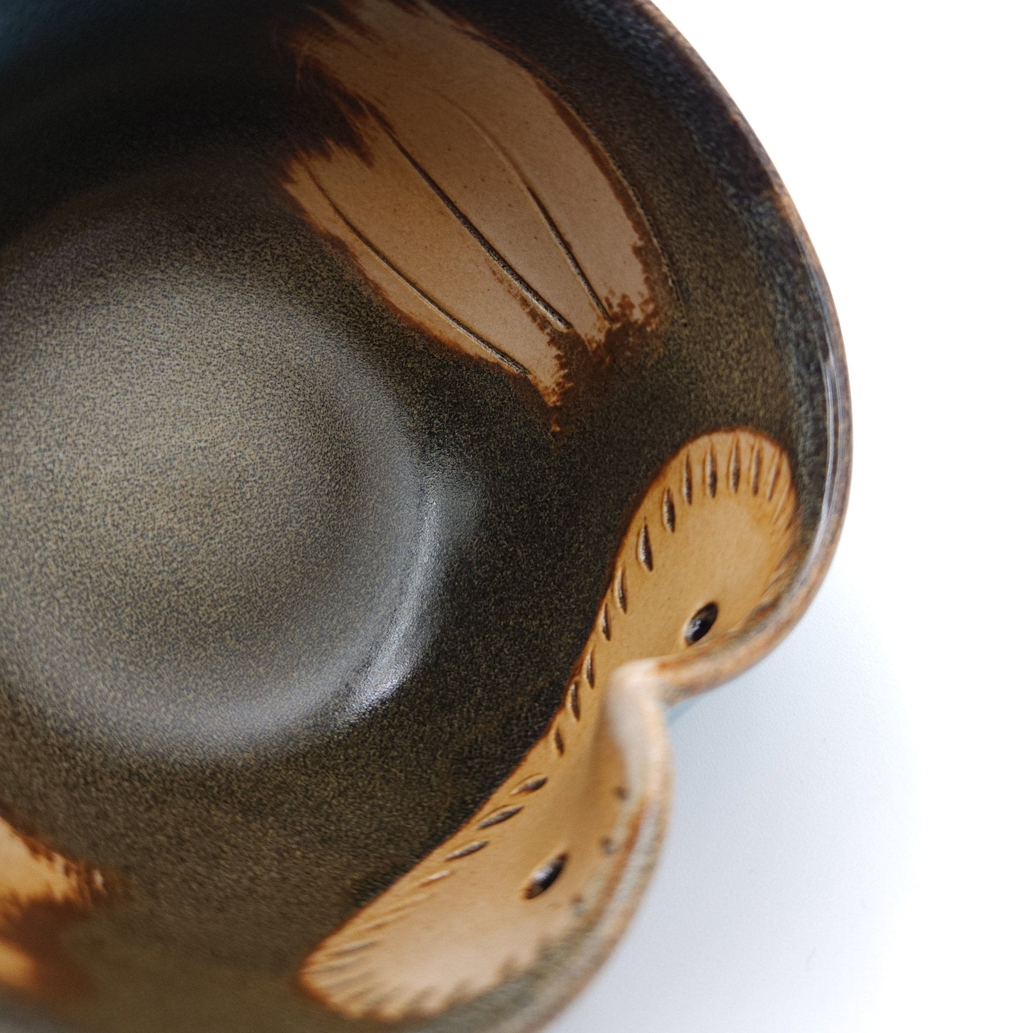 Inside detail of a Japanese Teacup made of pottery with an Owl motif.