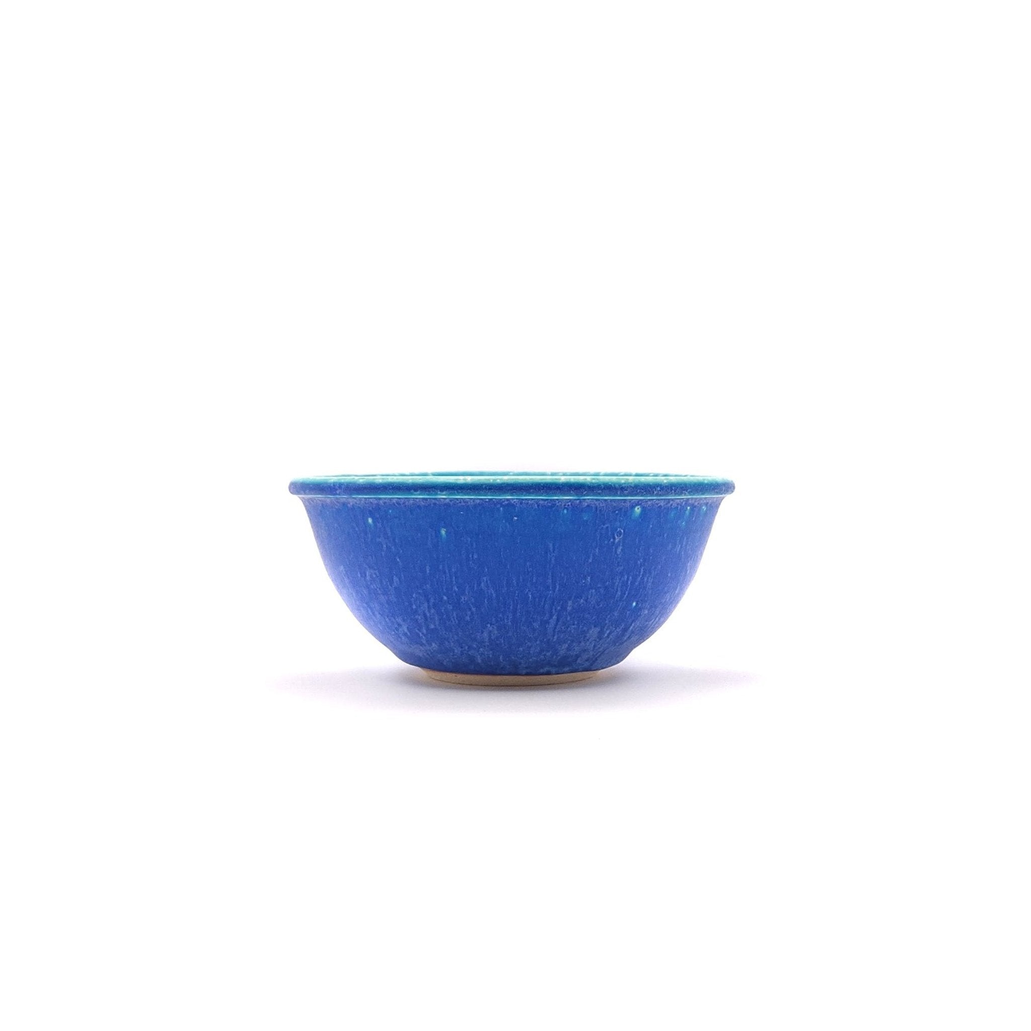 Side view of a Japanese pottery bowl, turquoise color.