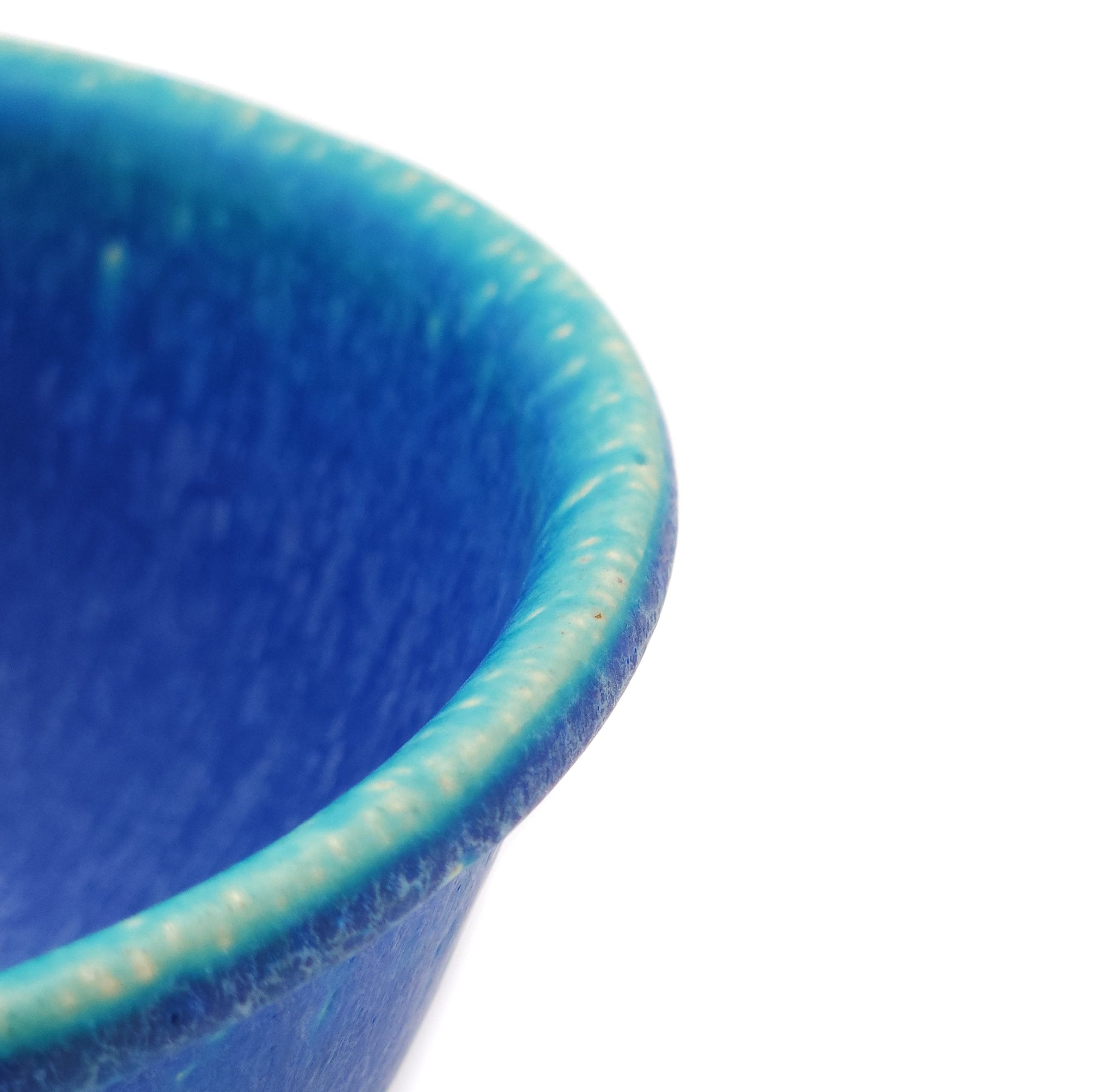 Side detail of a Japanese pottery bowl, turquoise color.