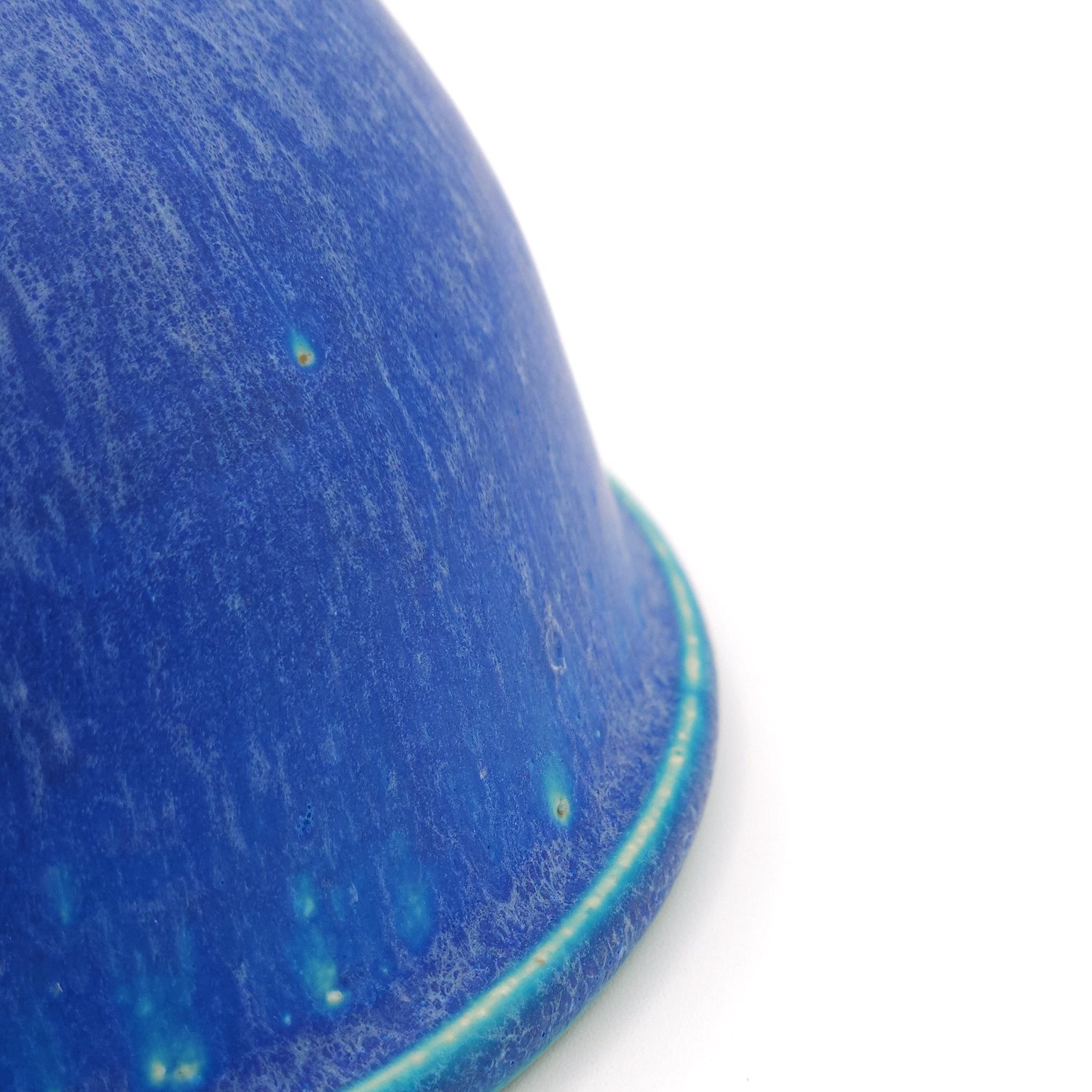 Detail of a Japanese pottery bowl, turquoise color. Side view