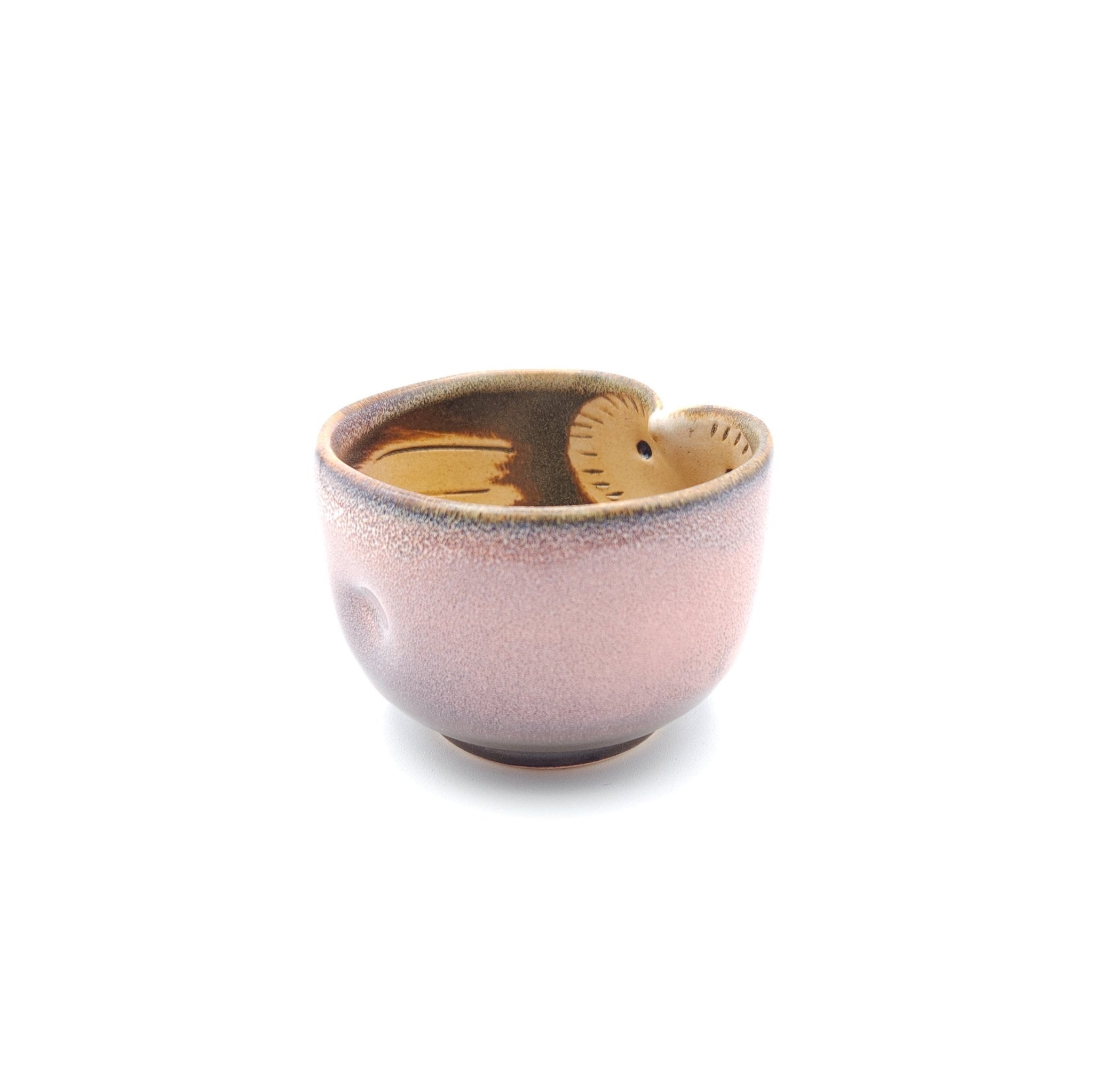 Side view of a Japanese pink Teacup made of pottery with an Owl motif. 3