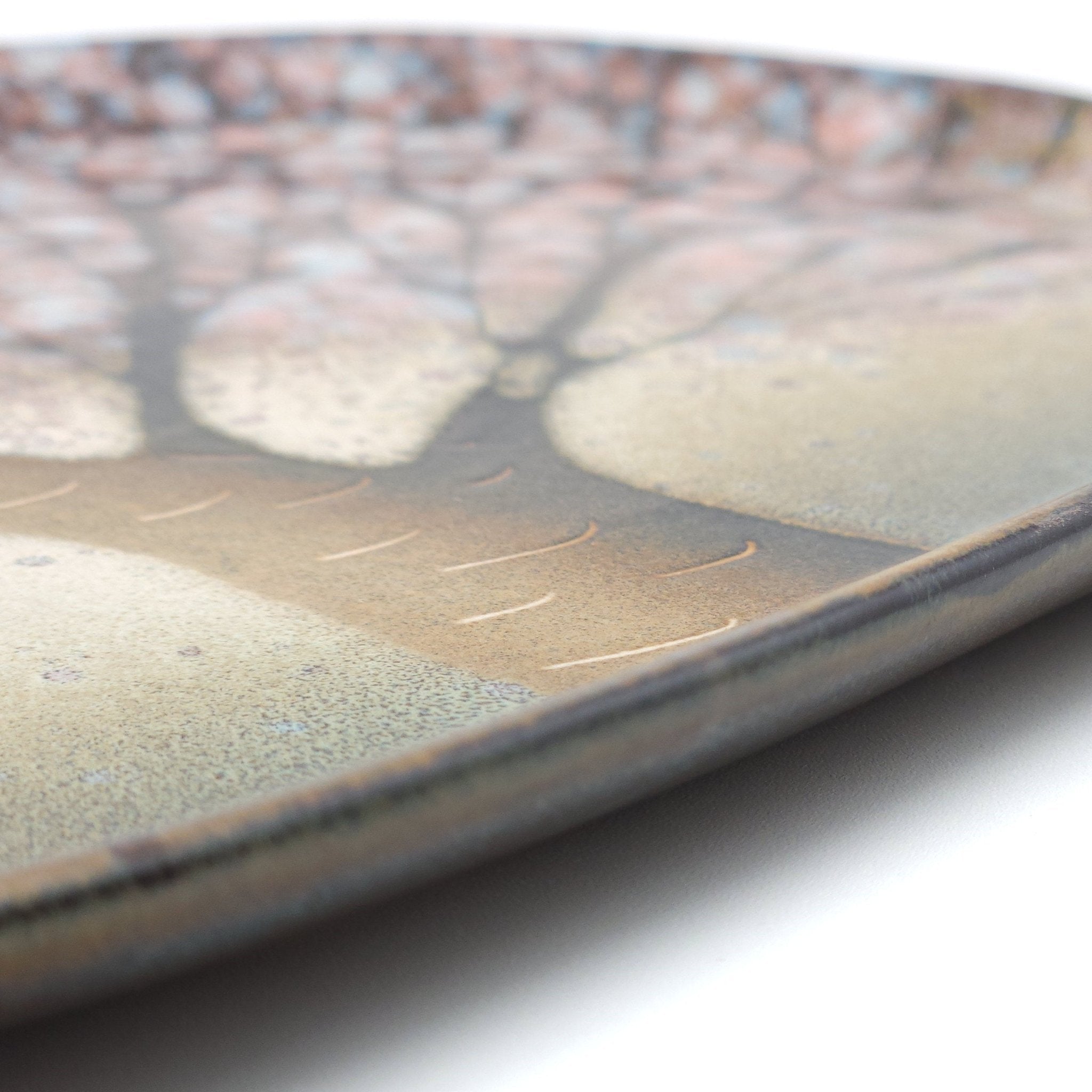 A detail view of a Japanese plate made of pottery with cherry blossoms motif in green background. 2