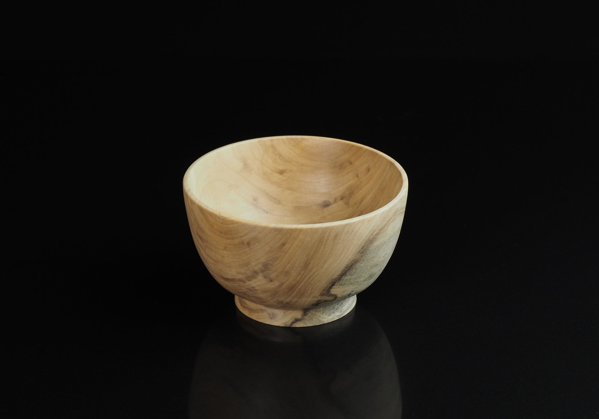 Japanese elm handcrafted wooden bowl on  background black. Tsukushi