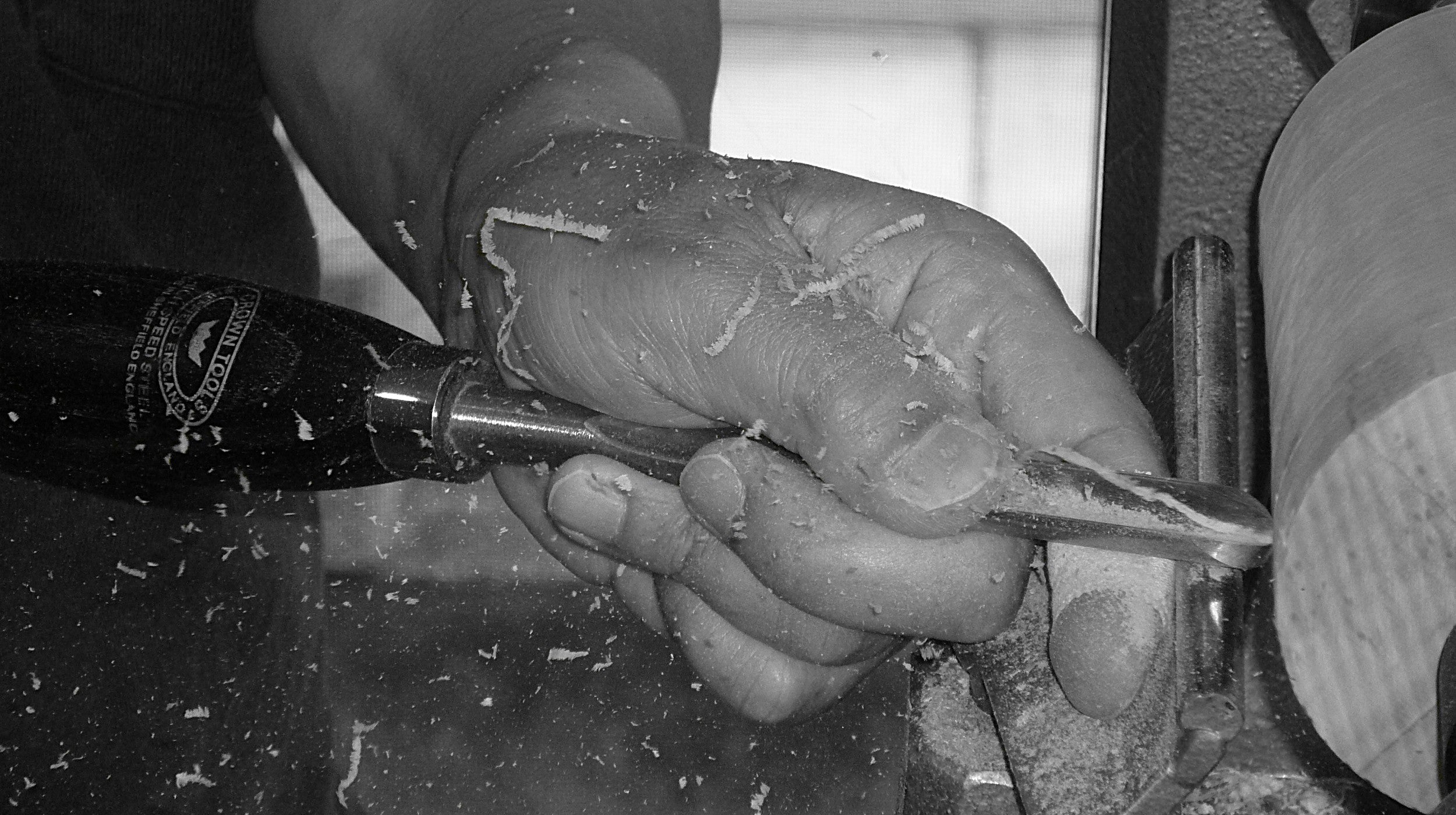 Close-up of a hand shaping Japanese wooden sake cup, Tsukushi