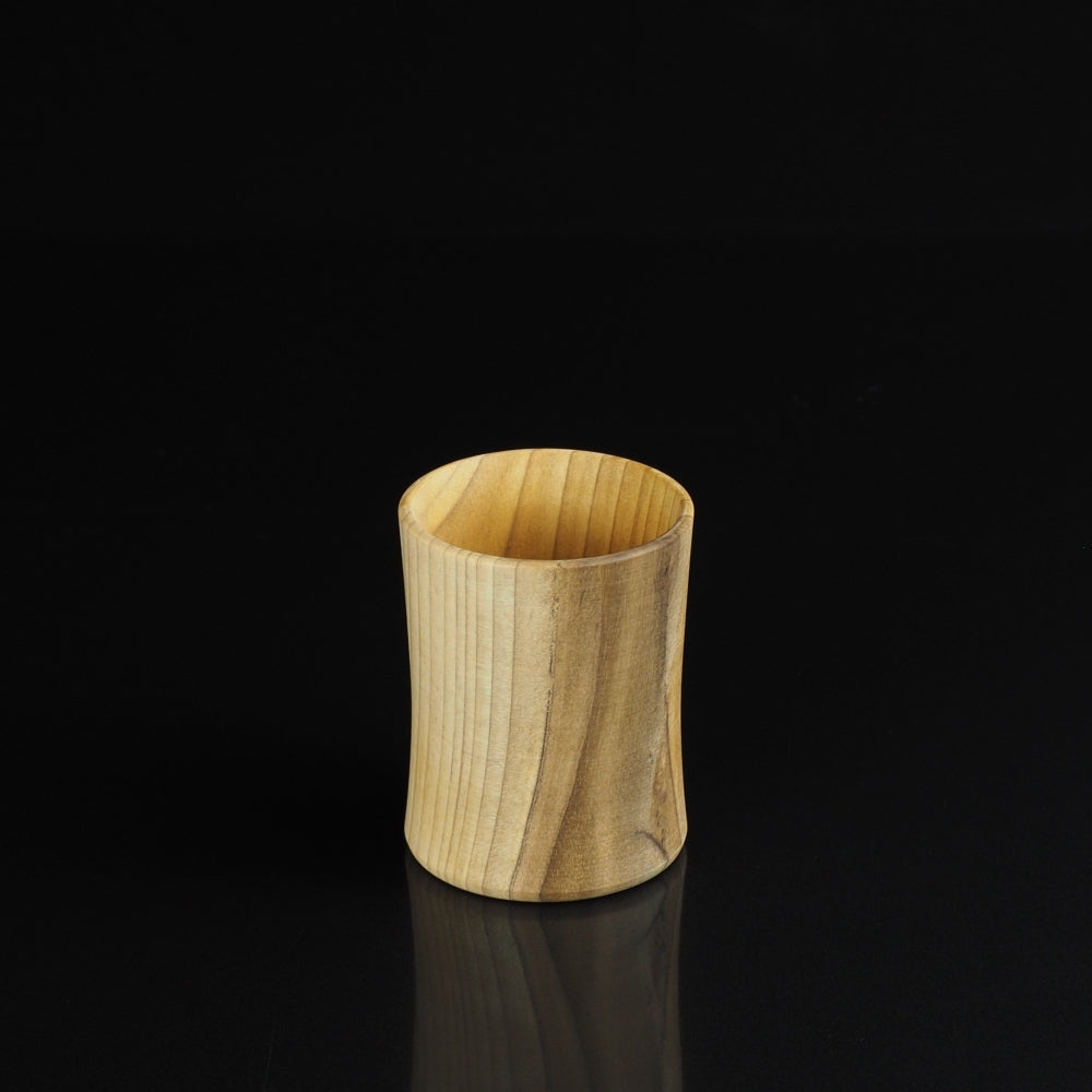Japanese handcrafted wooden Sake cup black background. Tsukushi