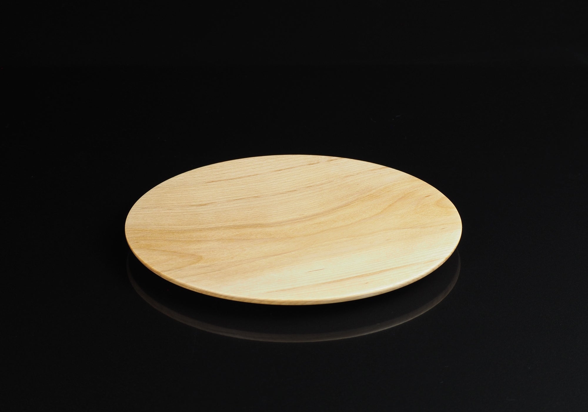 Japanese wood plate on black mirror background, Tsukushi.