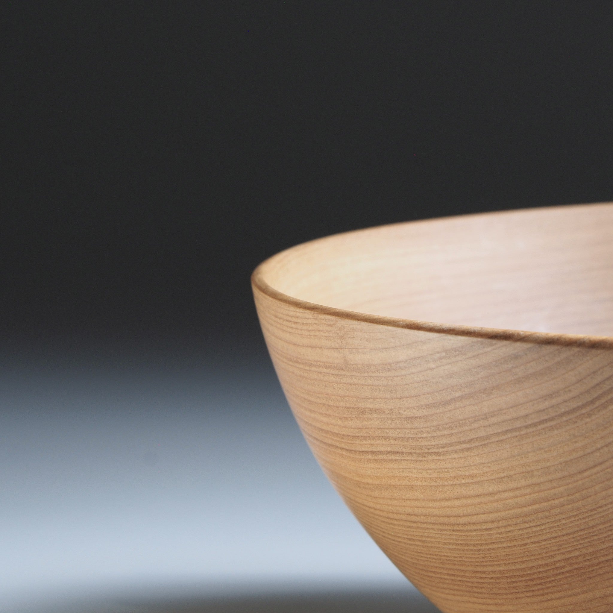 Japanese wooden bowl on a gray background. Tsukushi
