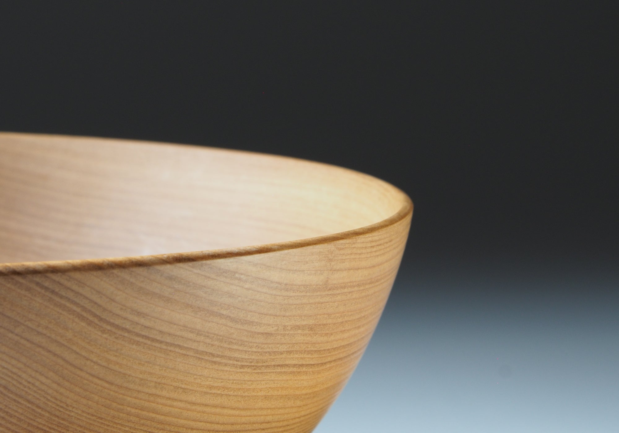 Close-up of a Japanese wooden bowl on a gray gradation background. Tsukushi
