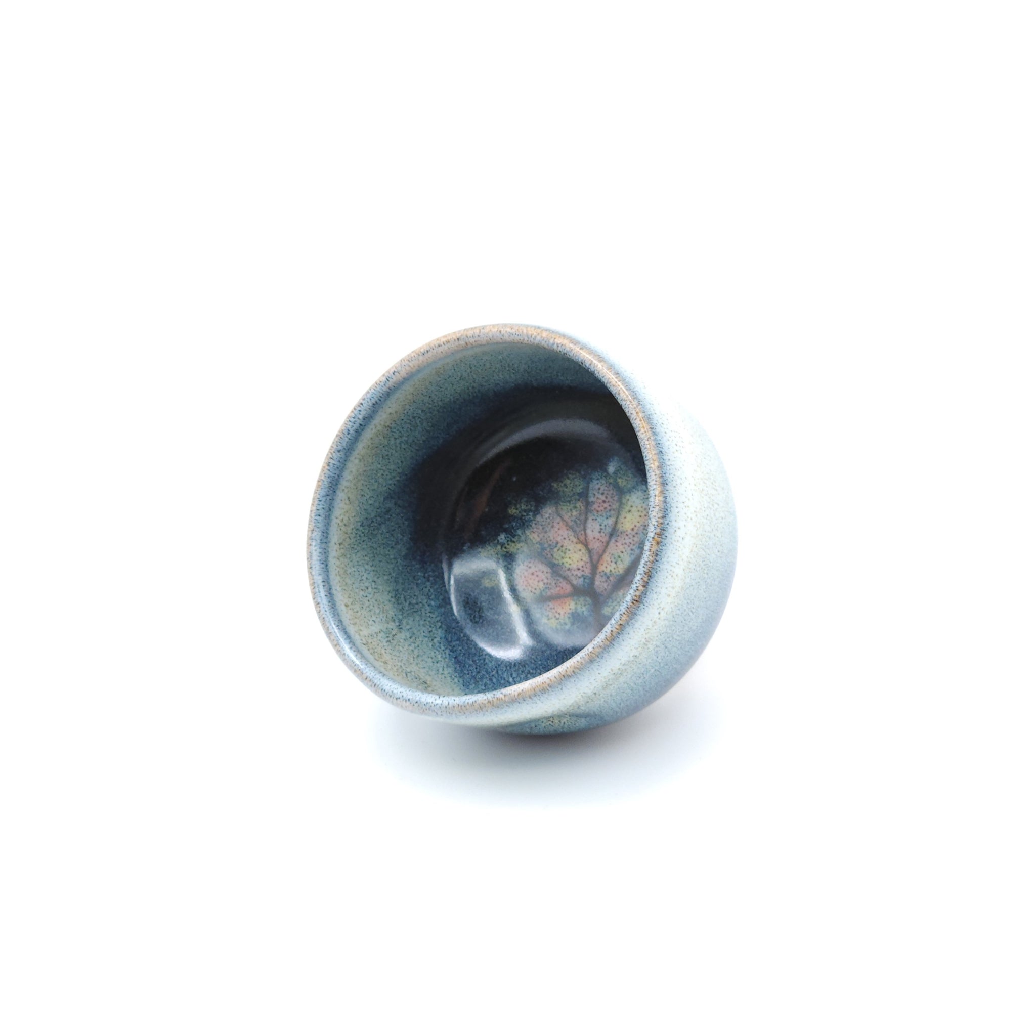 A blue Japanese Pottery Teacup, front side view. Tsukushi