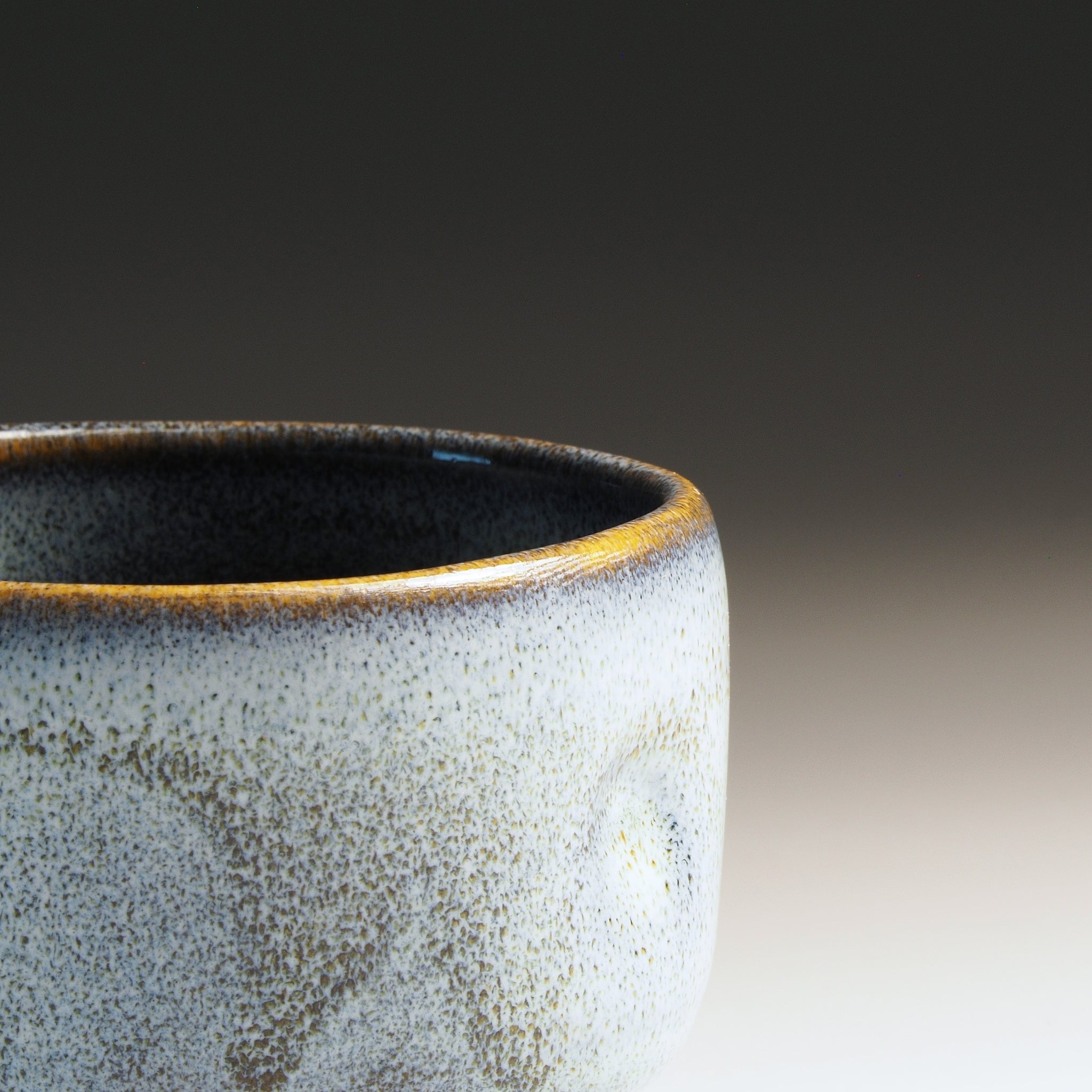 Detail of the rim of a Japanese yunomi with wabi-sabi glaze.