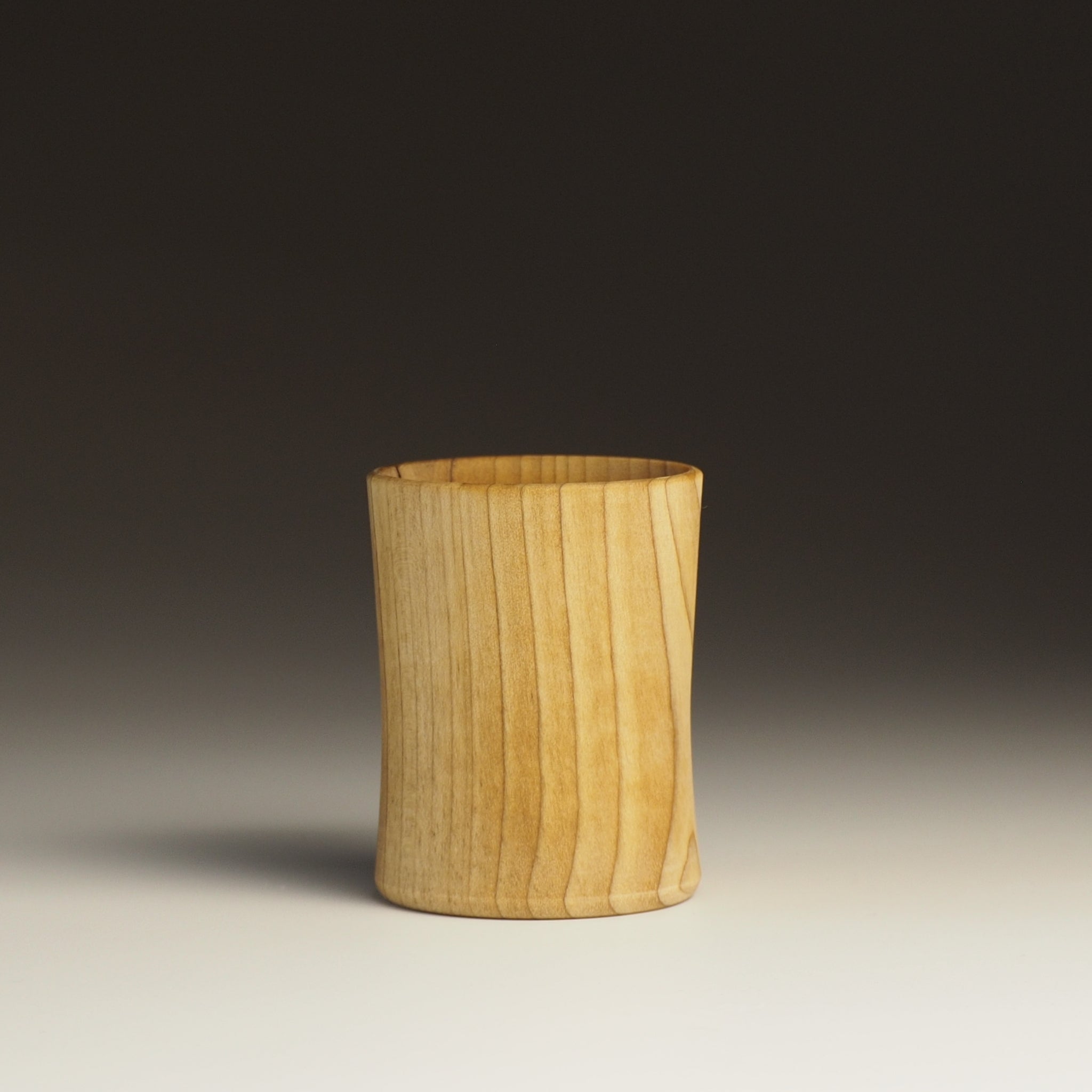 Japanese handcrafted wood sake cup black background. Tsukushi