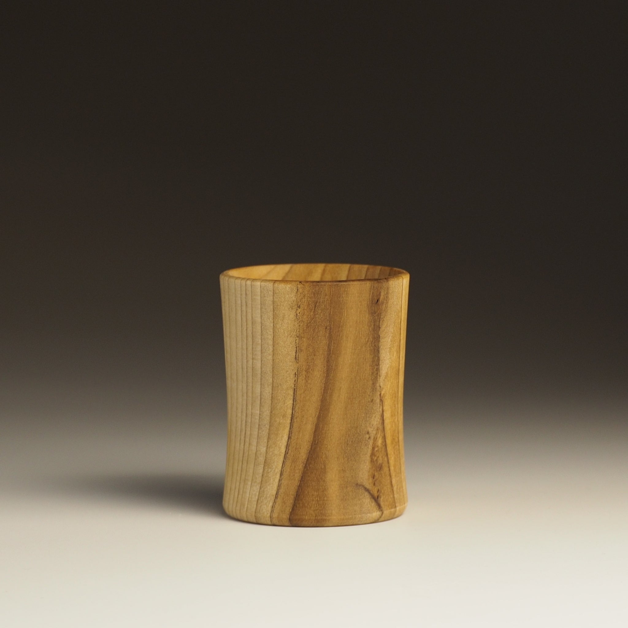 Japanese handcrafted wooden sake cup black to white gradation background. Tsukushi