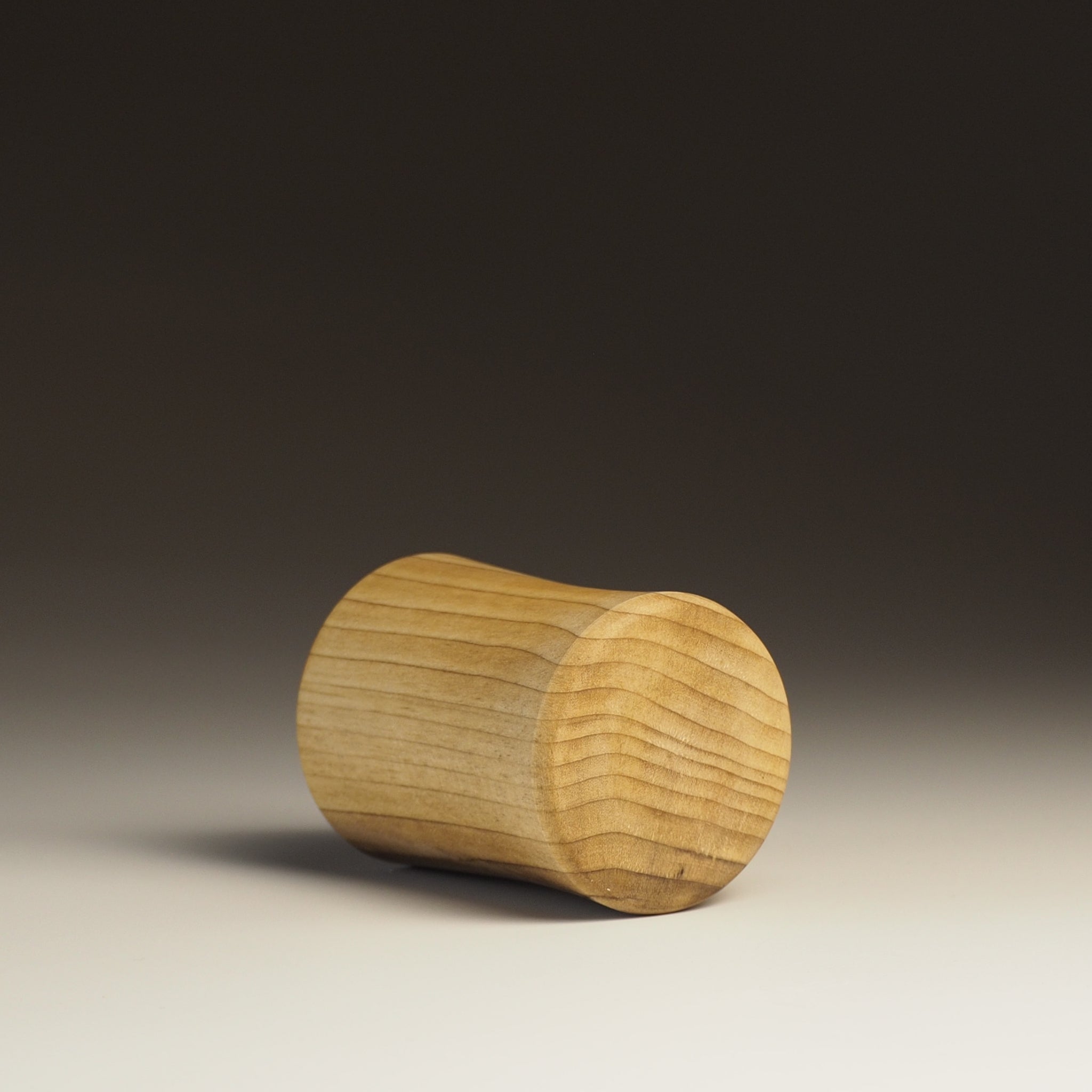 Japanese handcrafted wooden Sake cup on gradation background from back. Tsukushi