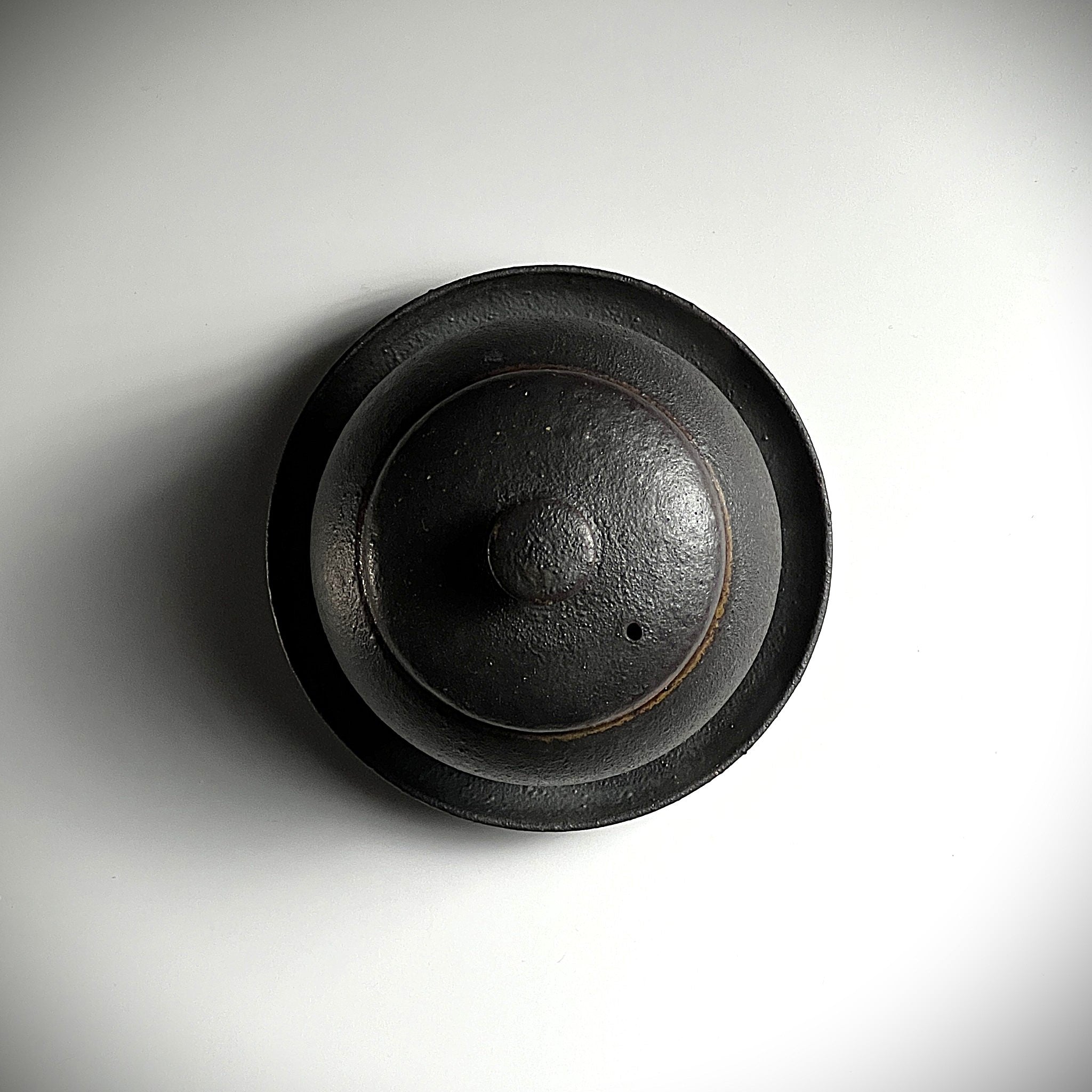 Top view of a Japanese Pottery Black chawanmushi bowl with lid and saucer. Tsukushi
