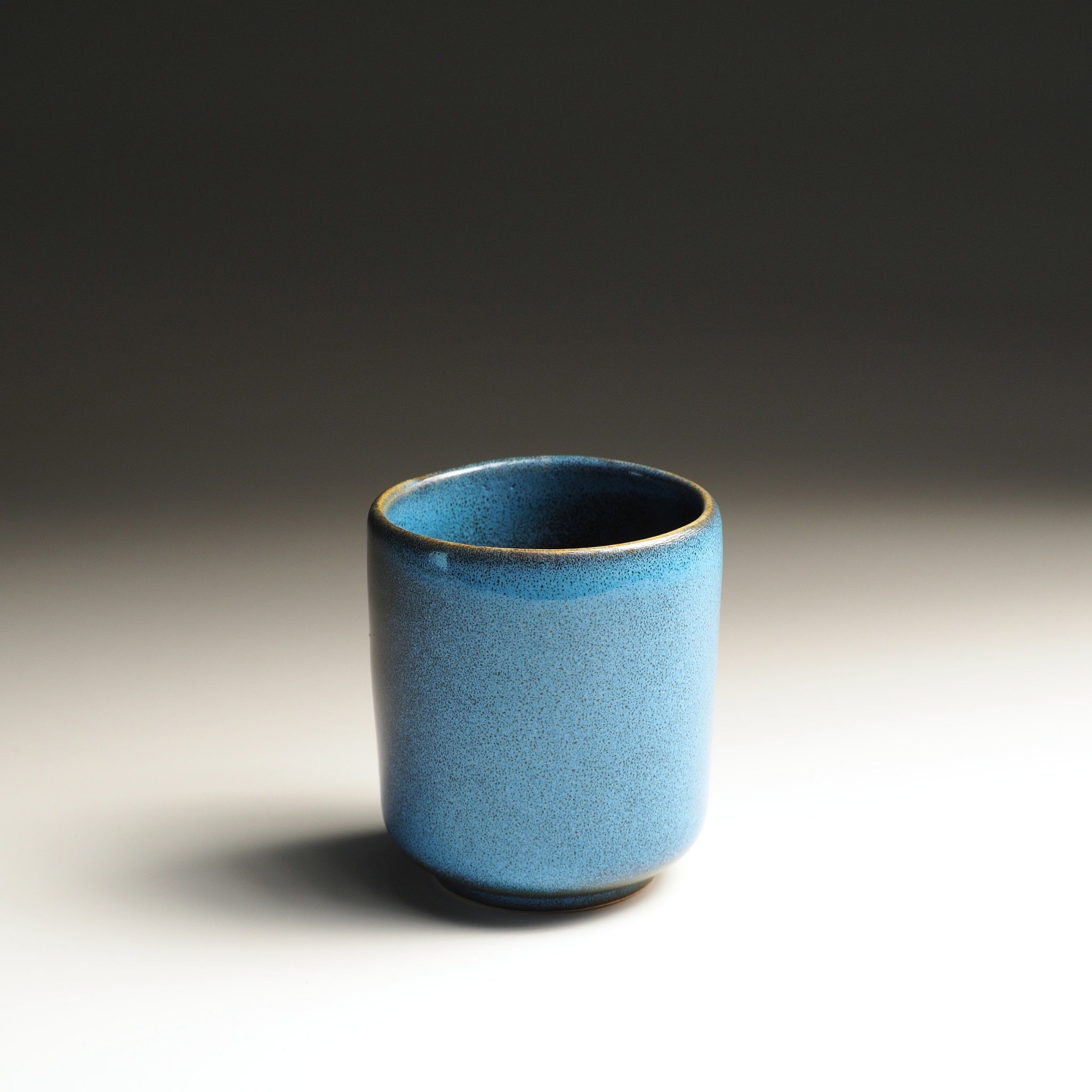 Blue Japanese ceramic yunomi cup with golden rim. Tsukushi