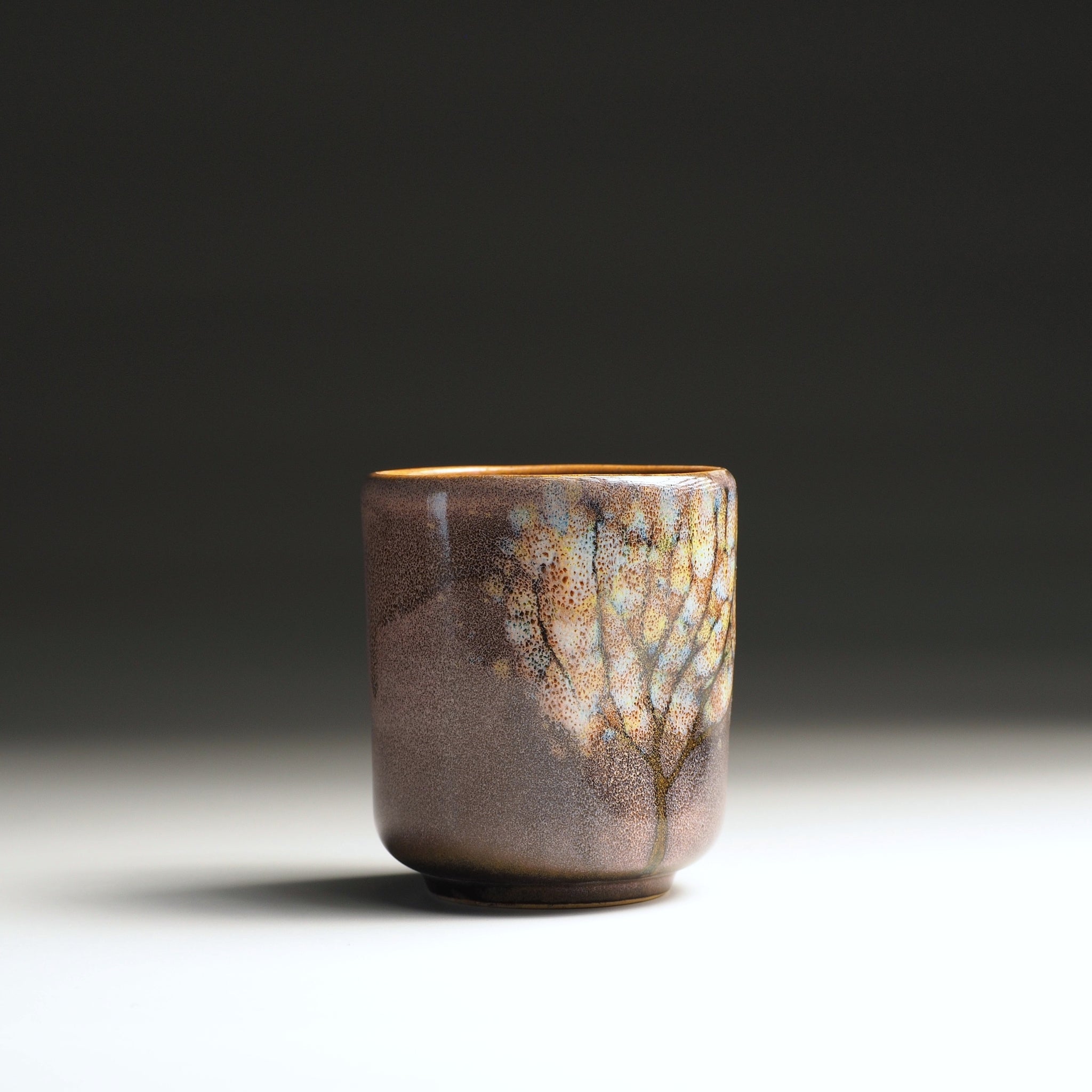 Front view of a handmade Japanese teacup with wabi-sabi pink-brown glaze, Tsukushi