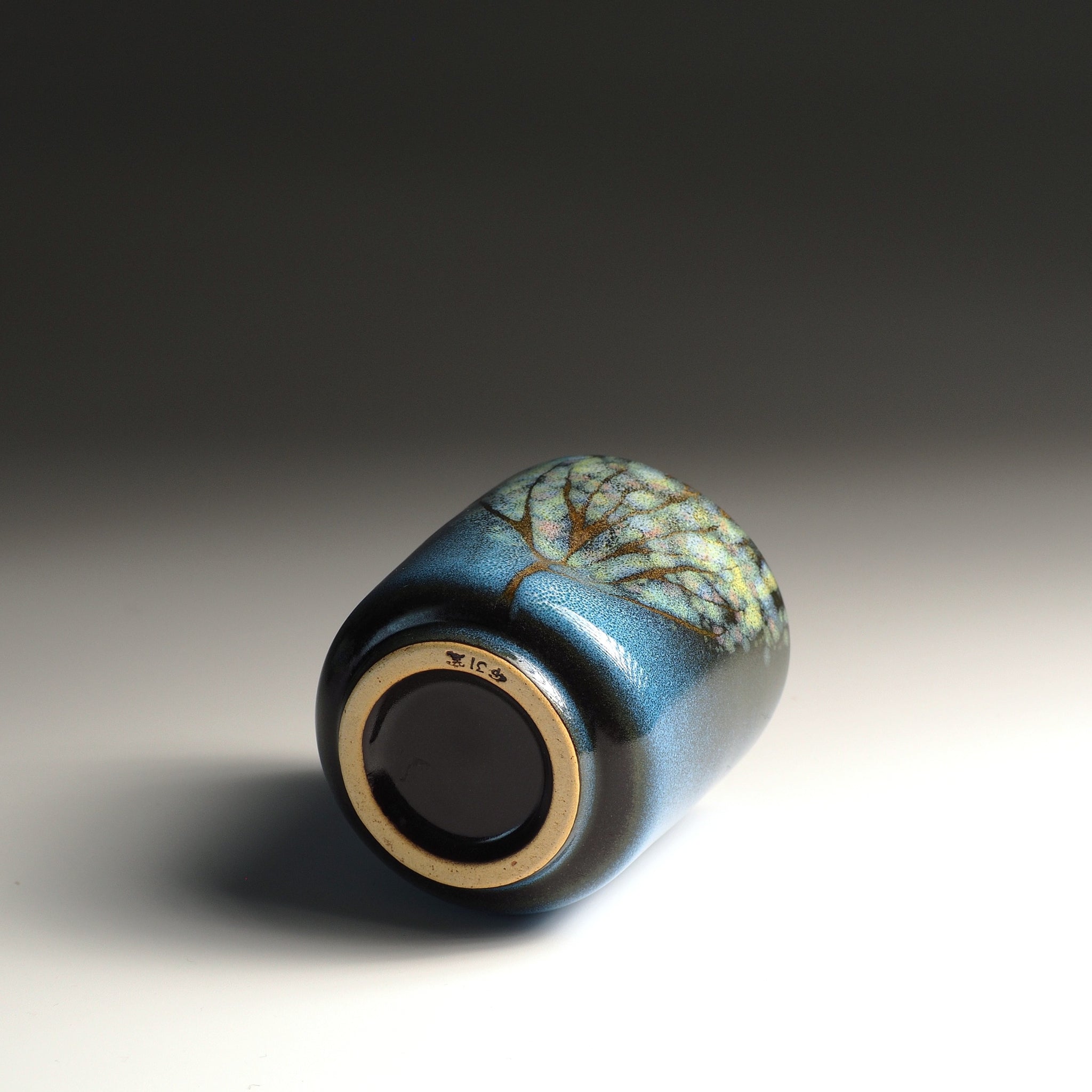 Bottom view of a Japanese yunomi teacup with decorative glaze. Tsukushi