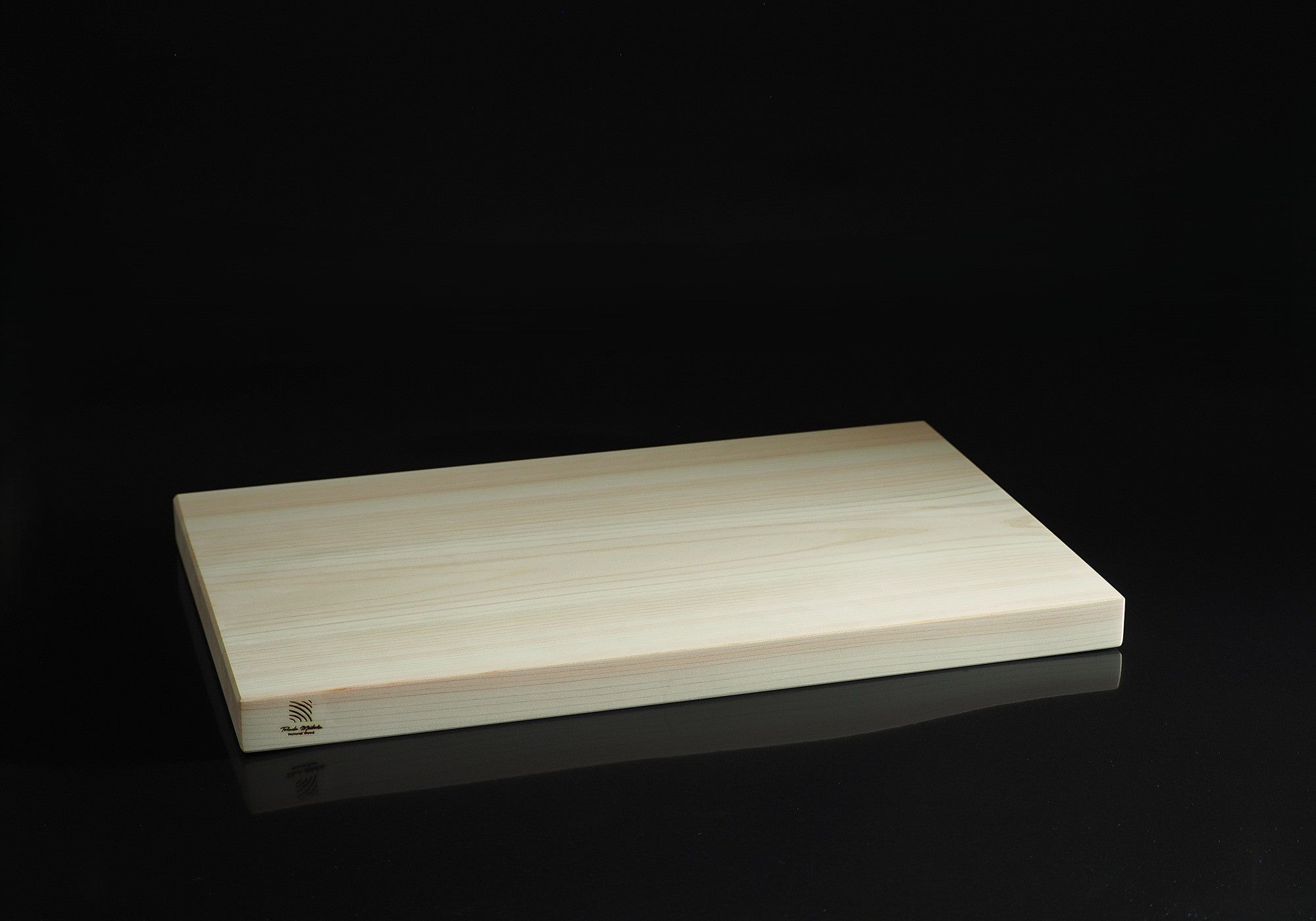 Wooden cutting board on a black background, Tsukushi