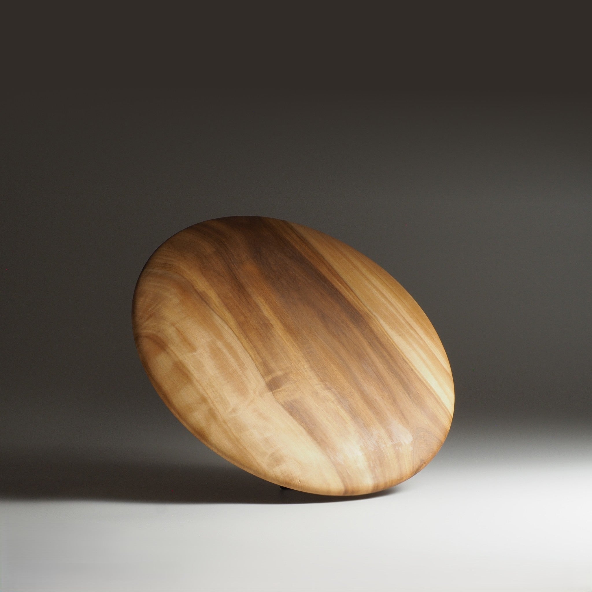 Back view of Japanese wooden dinner plate on a gray gradation background. Tsukushi
