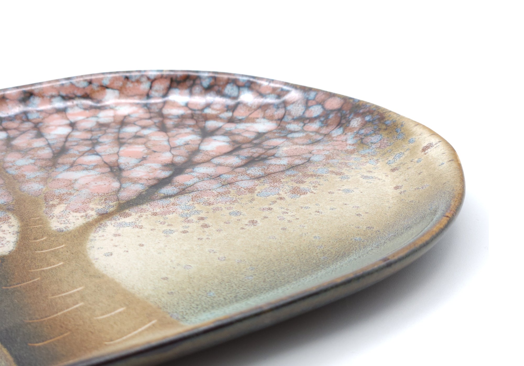 Detail of a Japanese pottery pink plate with Cherry blossoms